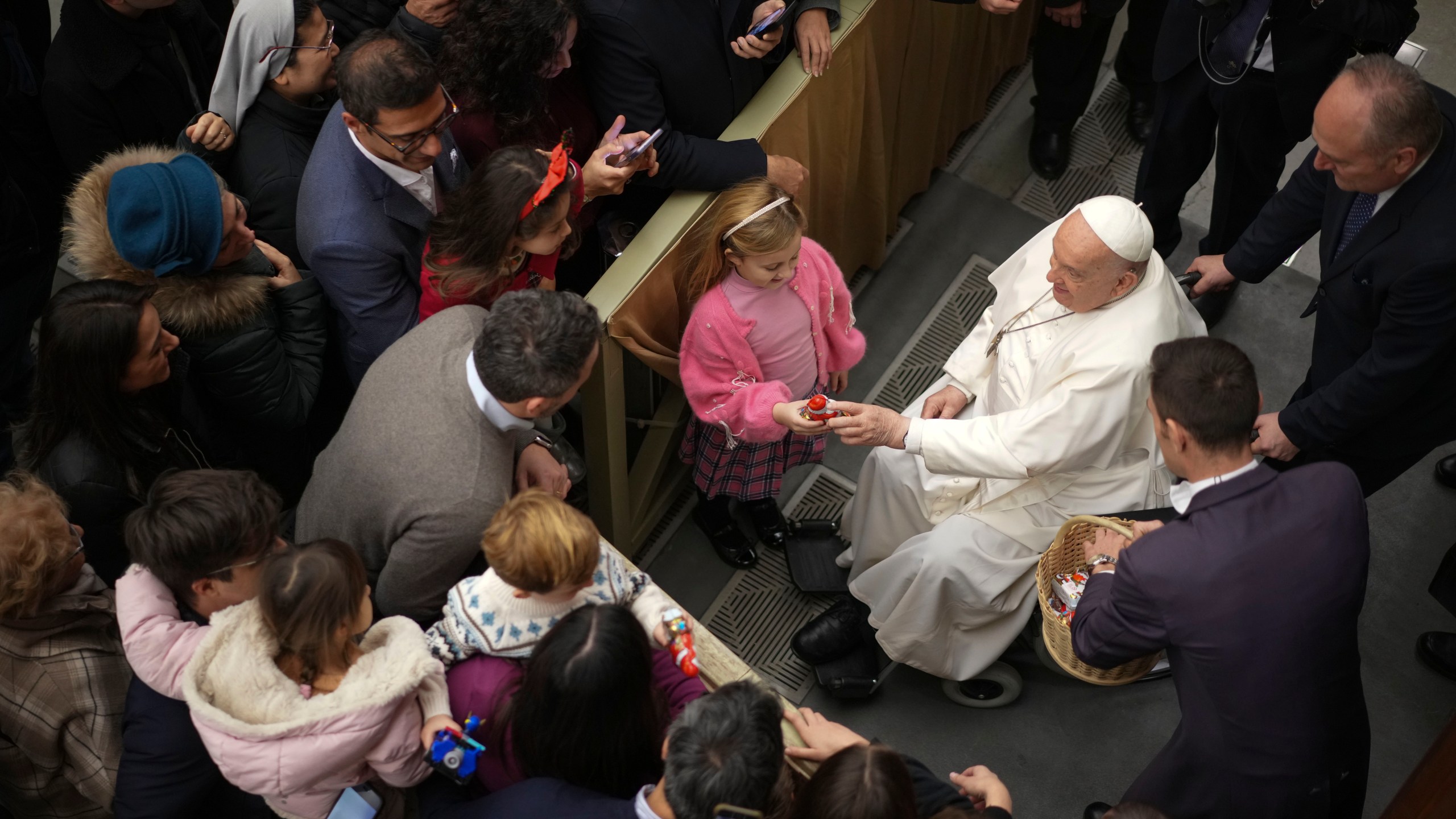 Pope Francis exchanges season greetings with Vatican employees, in the Paul VI Hall at the Vatican, Saturday, Dec. 21, 2024. (AP Photo/Andrew Medichini)