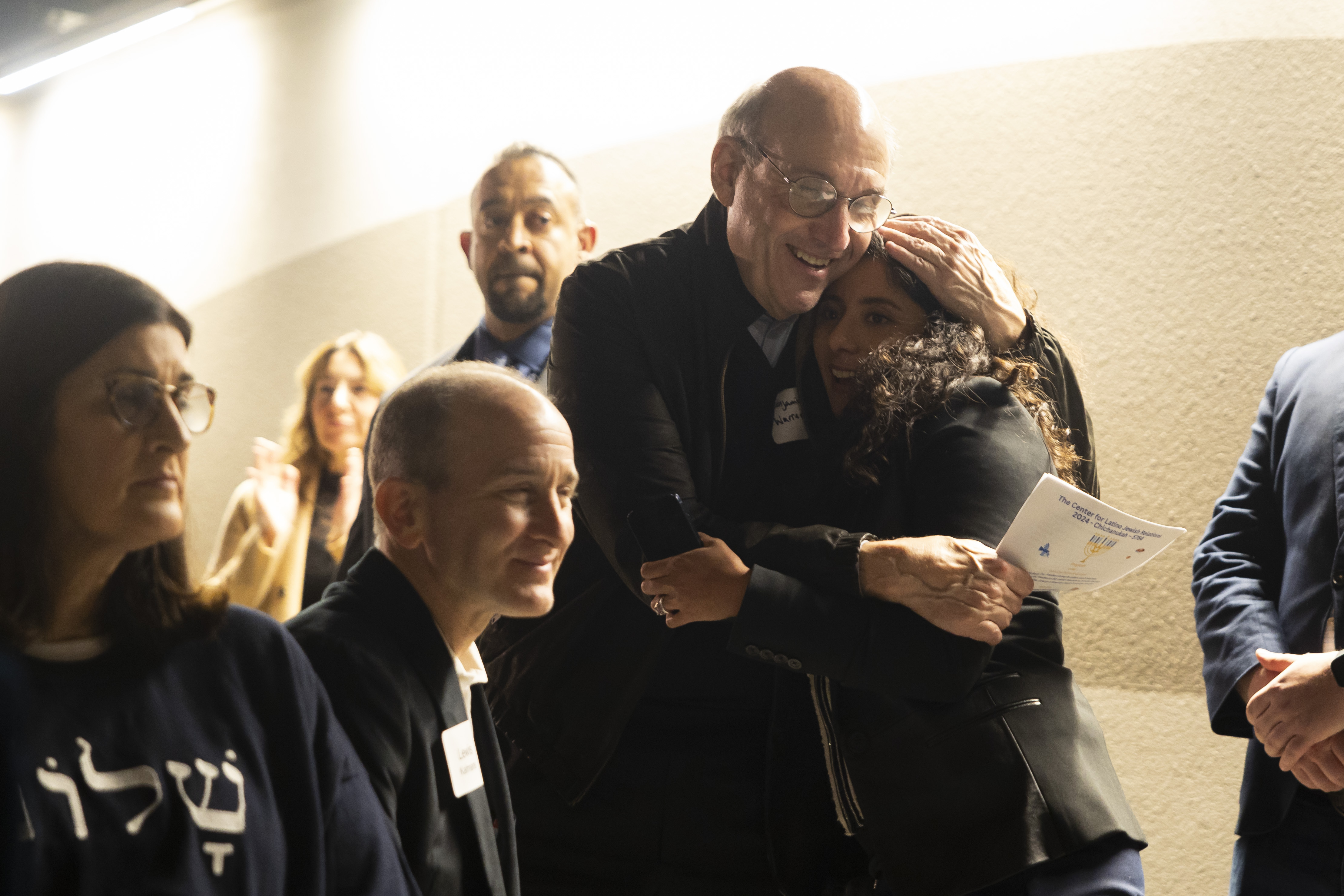 Benjamin Warren hugs Harris County Judge Lina Hidalgo after she spoke during a Chicanukah event at Holocaust Museum Houston on Thursday, December 19, 2024, in Houston. (AP Photo/Annie Mulligan)