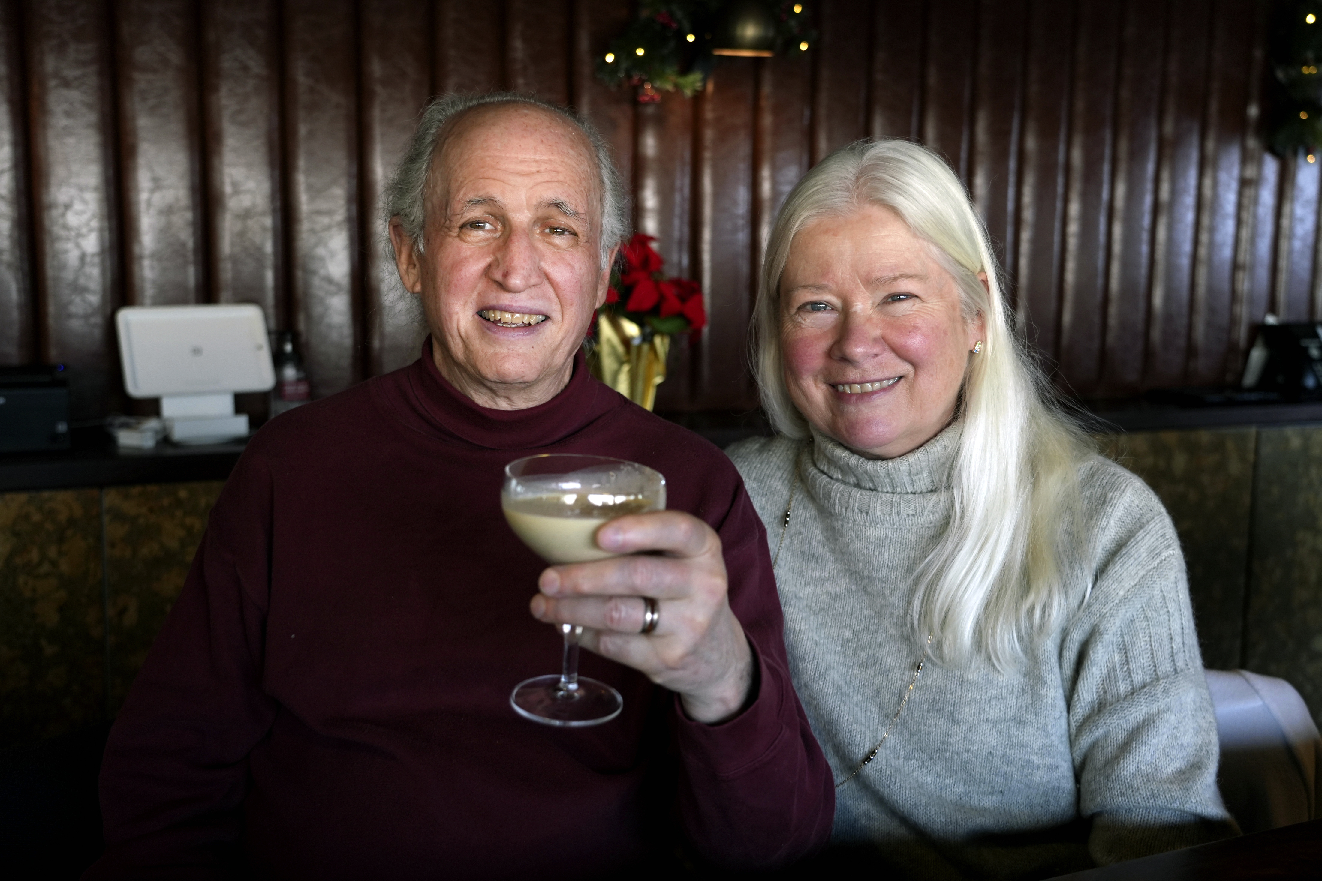 Phil and Laurie Kenny drink eggnog at Scoma's Restaurant in San Francisco on Dec. 10, 2024. The eggnog is prepared 11 months in advance. (AP Photo/Terry Chea)