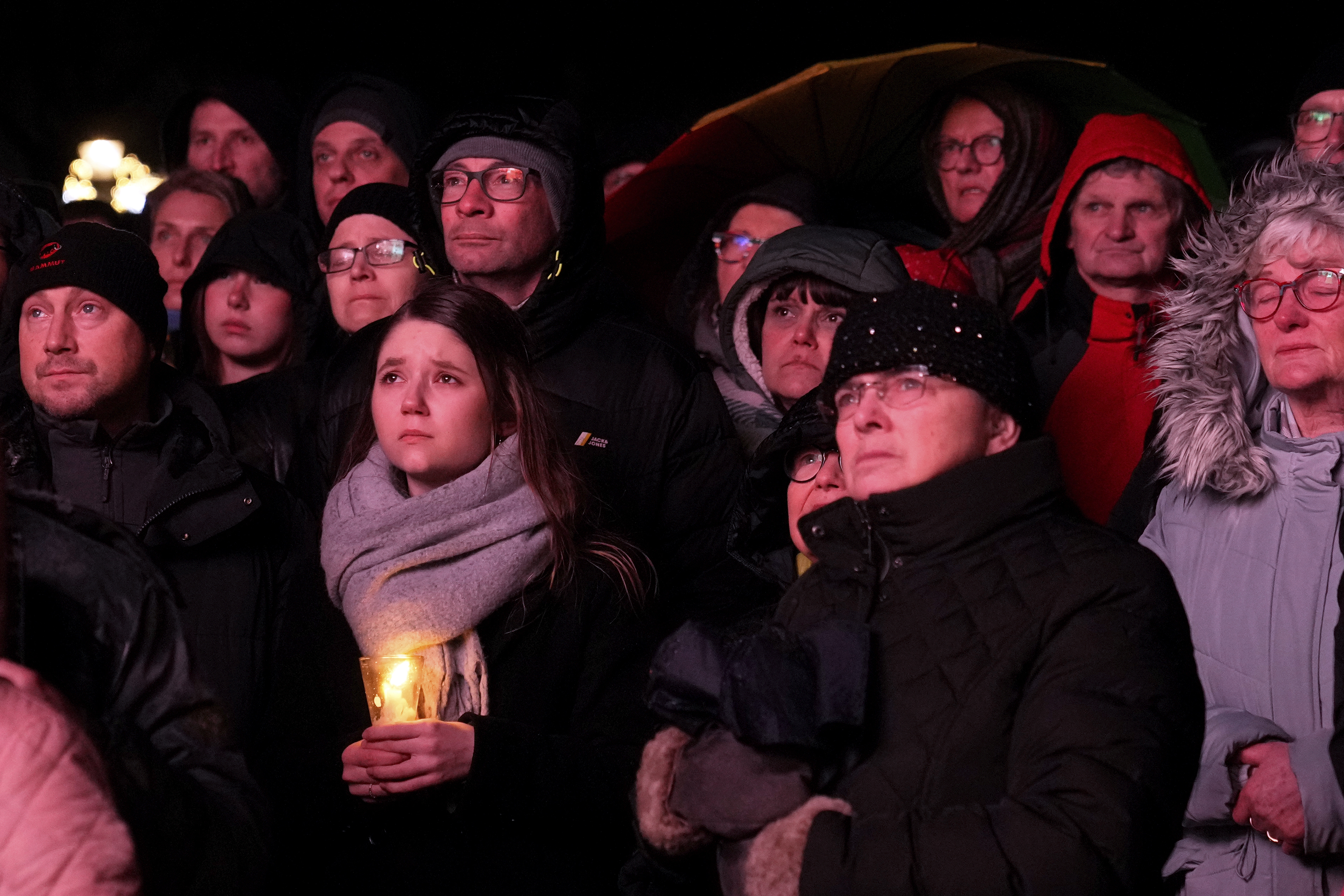 People outside Magdeburg Cathedral follow a memorial service for victims of Friday's Christmas Market attack, where a car drove into a crowd, in Magdeburg, Germany, Saturday, Dec. 21, 2024. (AP Photo/Ebrahim Noroozi)