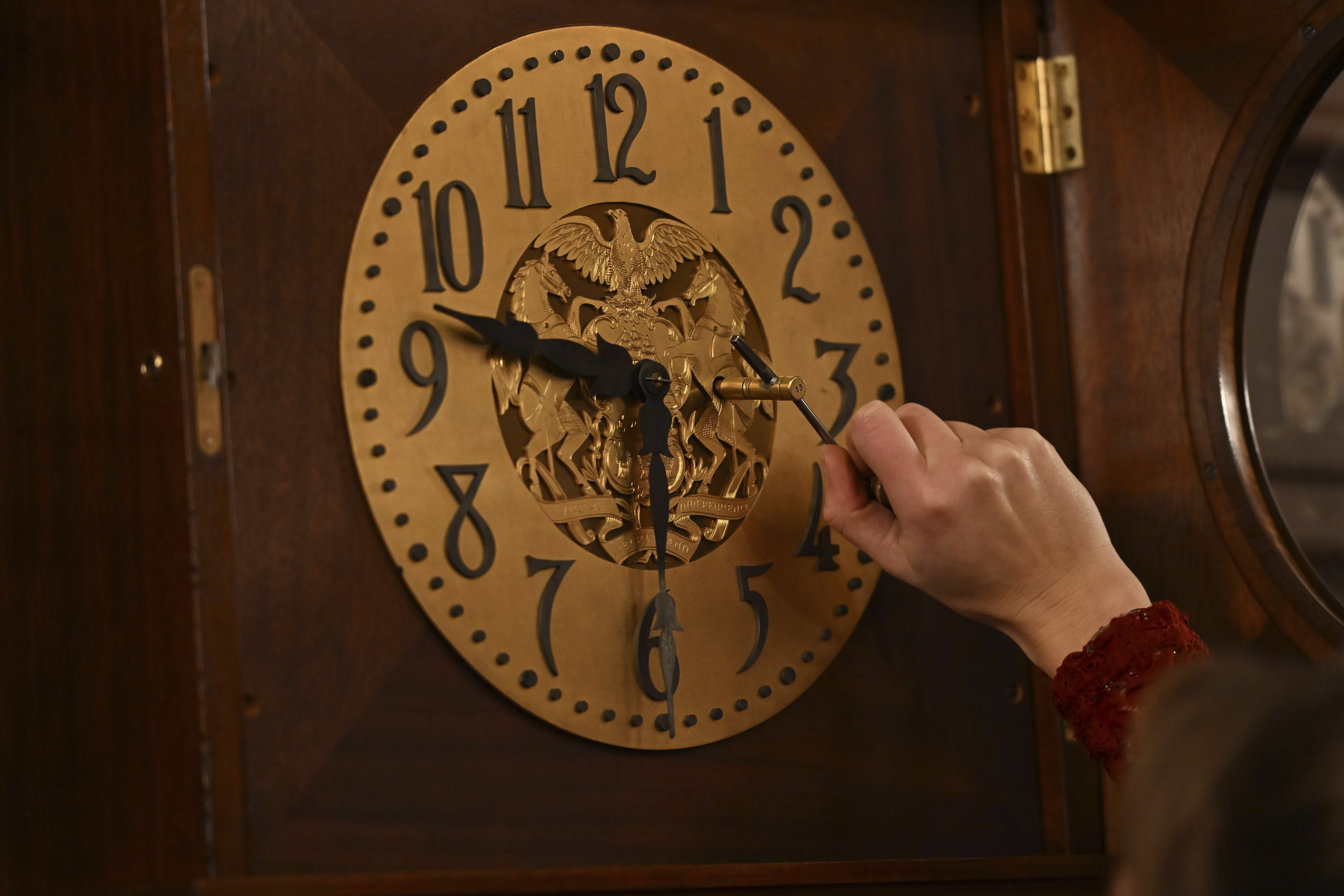 Bethany Gill winds a clock in the Pennsylvania Supreme Court chamber, Dec. 13, 2024, in Harrisburg, Pa. It's one of 273 clocks in Pennsylvania's ornate state Capitol complex buildings that must be wound by hand. (AP Photo/Marc Levy)