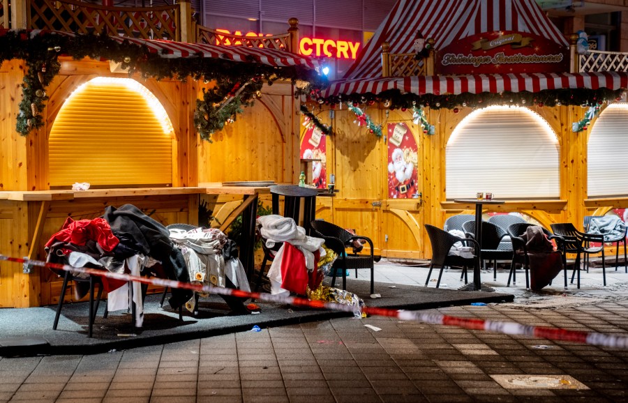 Clothes and blankets lie on chairs at the Christmas market, where a car drove into a crowd on Friday evening, in Magdeburg, Germany, Sunday, Dec. 22, 2024. (AP Photo/Michael Probst)