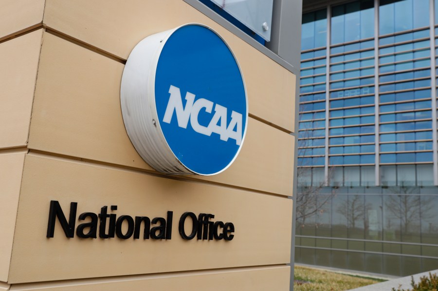 FILE - Signage at the headquarters of the NCAA is viewed in Indianapolis, March 12, 2020. A U.S. appeals court in Philadelphia has ruled that some college athletes may qualify as employees under federal wage-and-hour laws. The court says a test should be developed to differentiate students who play college sports for fun from those whose effort "crosses the legal line into work" that benefits the school. The NCAA had hoped to have the case dismissed.(AP Photo/Michael Conroy, File)