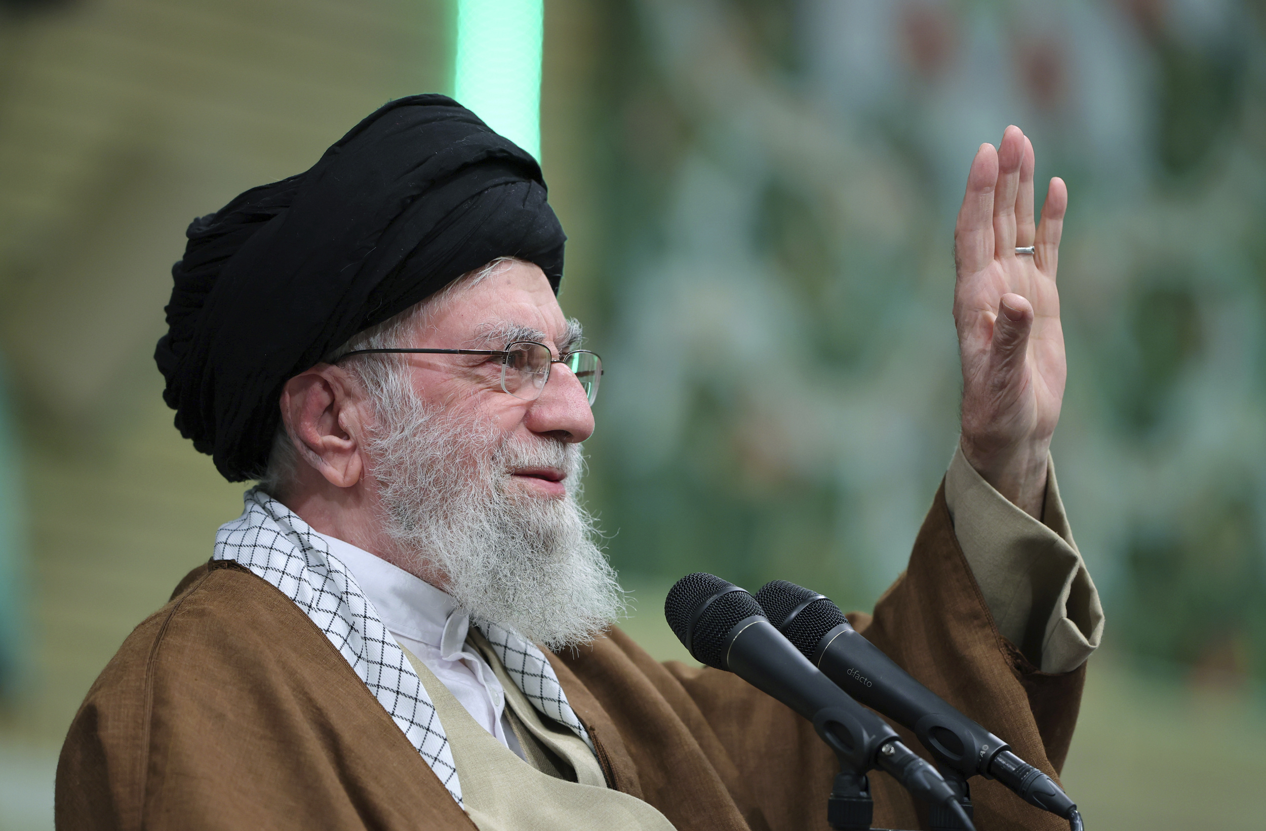 In this photo released by an official website of the office of the Iranian supreme leader, Supreme Leader Ayatollah Ali Khamenei waves to the crowd during a meeting in Tehran, Iran, Sunday, Dec. 22, 2024. (Office of the Iranian Supreme Leader via AP)