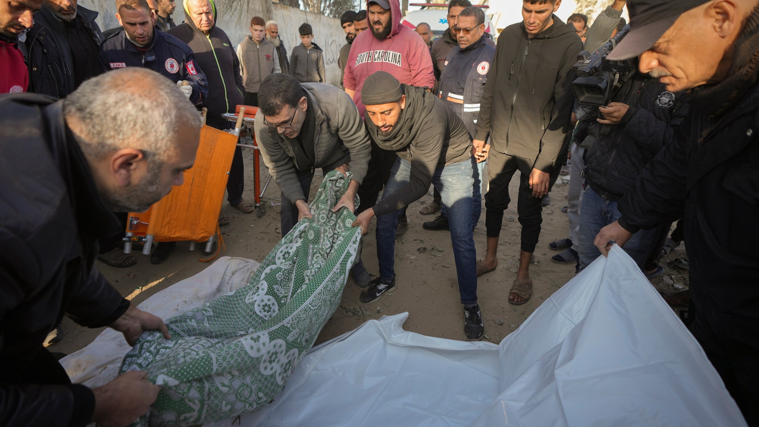 Bodies of victims of an Israeli strike on a home in Deir al-Balah late Saturday are prepared for the funeral outside the Al-Aqsa Martyrs Hospital in Deir al-Balah Sunday, Dec. 22, 2024. At least eight people were killed according to the hospital which received the bodies.(AP Photo/Abdel Kareem Hana)