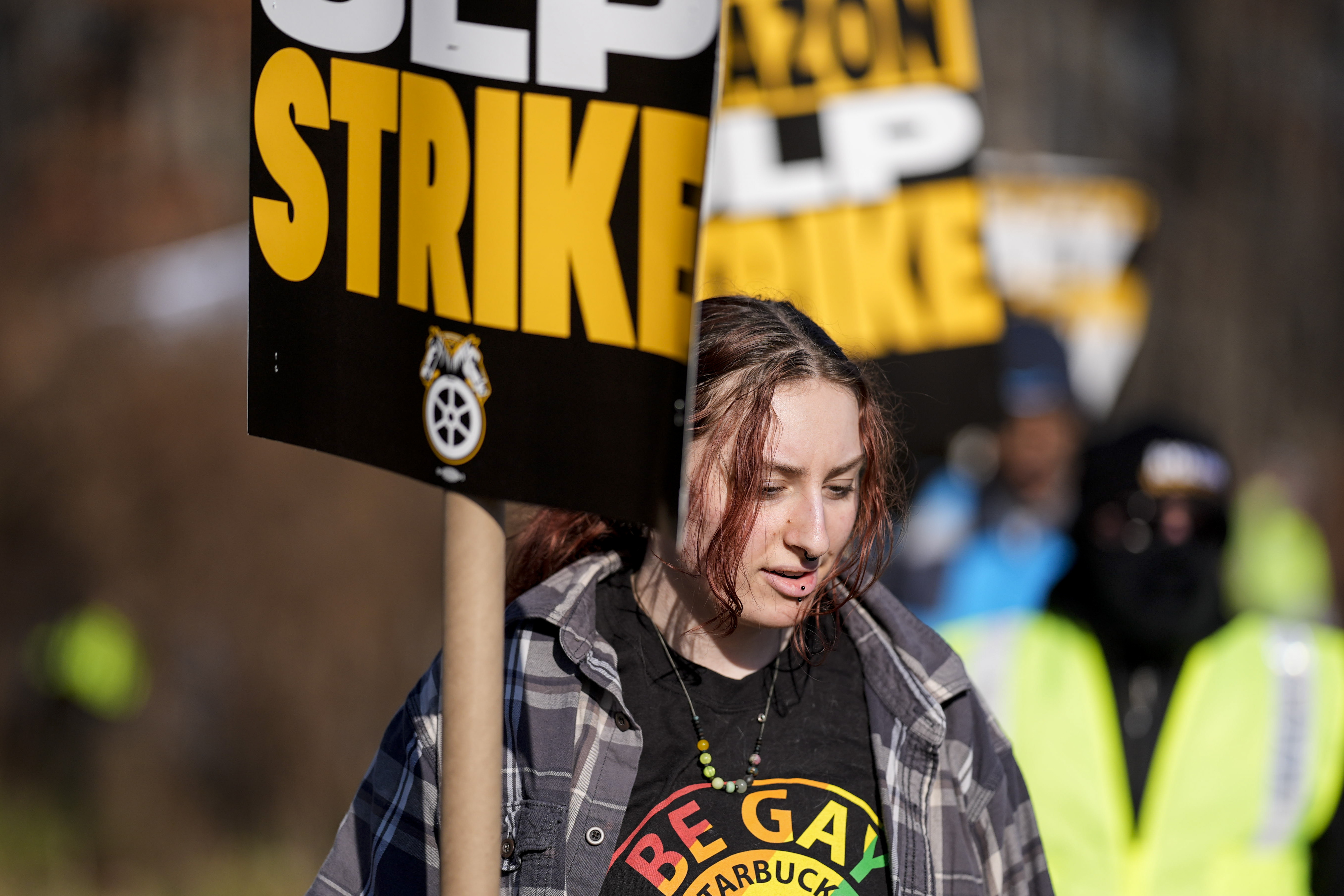 A pro-union demonstrator marches outside an Amazon warehouse, Friday, Dec. 20, 2024, in Alpharetta, Ga. (AP Photo/Mike Stewart)