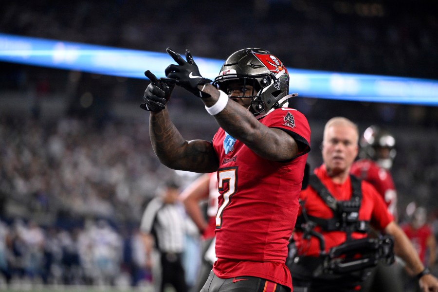 Tampa Bay Buccaneers running back Bucky Irving celebrates after rushing for a touchdown against th eDallas Cowboys in the first half of an NFL football game in Arlington, Texas, Sunday, Dec. 22, 2024. (AP Photo/Jerome Miron)