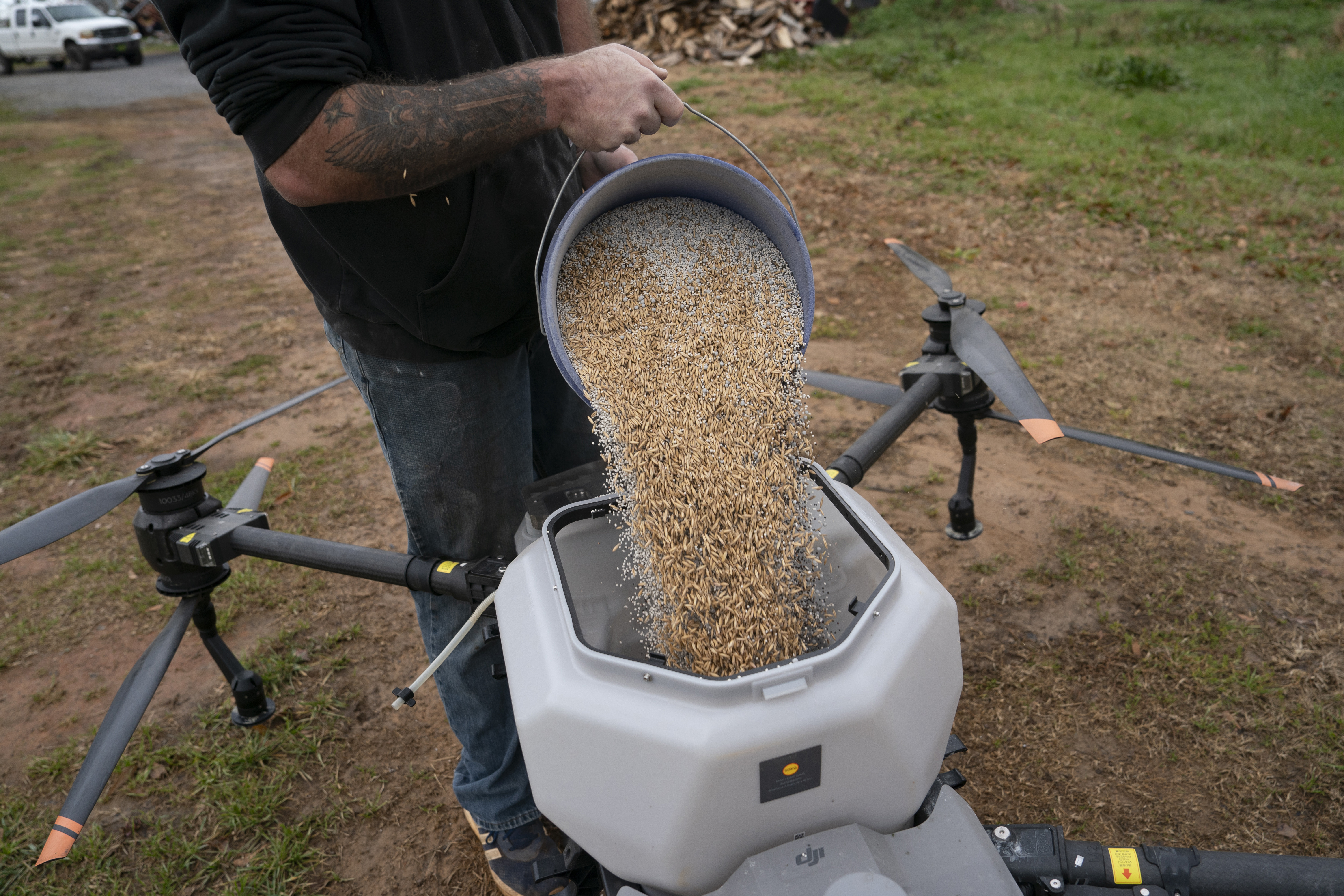 Russell Hedrick prepares a DJI drone to put crop cover on his farm, Tuesday, Dec. 17, 2024, in Hickory, N.C. (AP Photo/Allison Joyce)