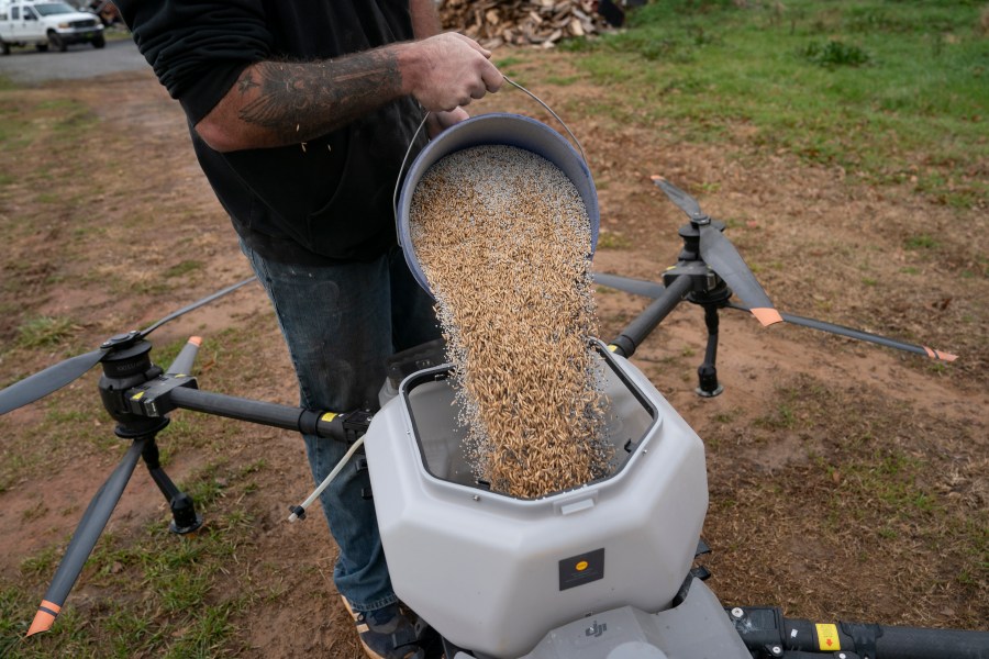 Russell Hedrick prepares a DJI drone to put crop cover on his farm, Tuesday, Dec. 17, 2024, in Hickory, N.C. (AP Photo/Allison Joyce)