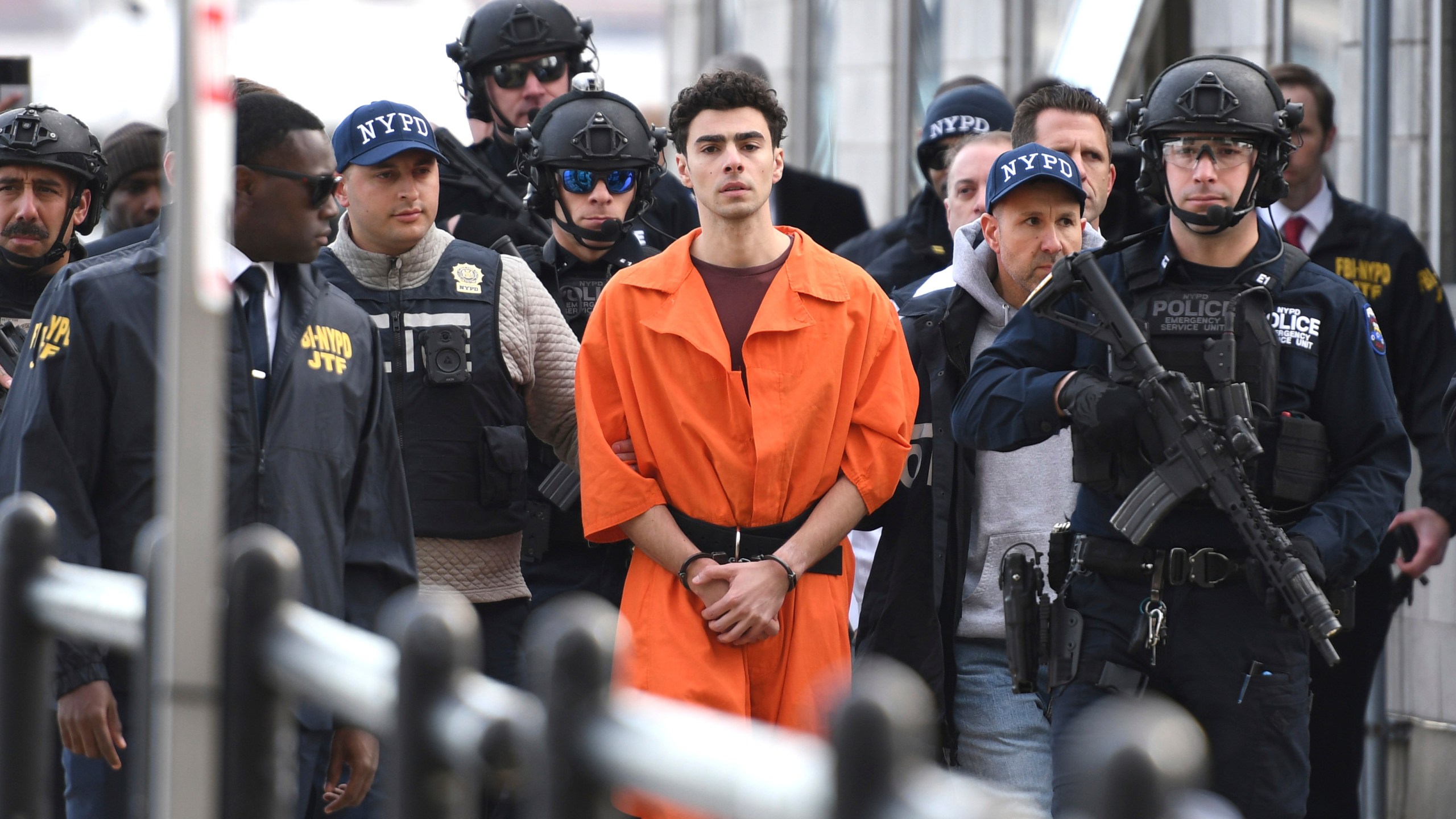 Luigi Mangione, charged with the fatal shooting of UnitedHealthcare CEO Brian Thompson, is escorted by police in New York, Dec. 19, 2024. (AP Photo/Pamela Smith)