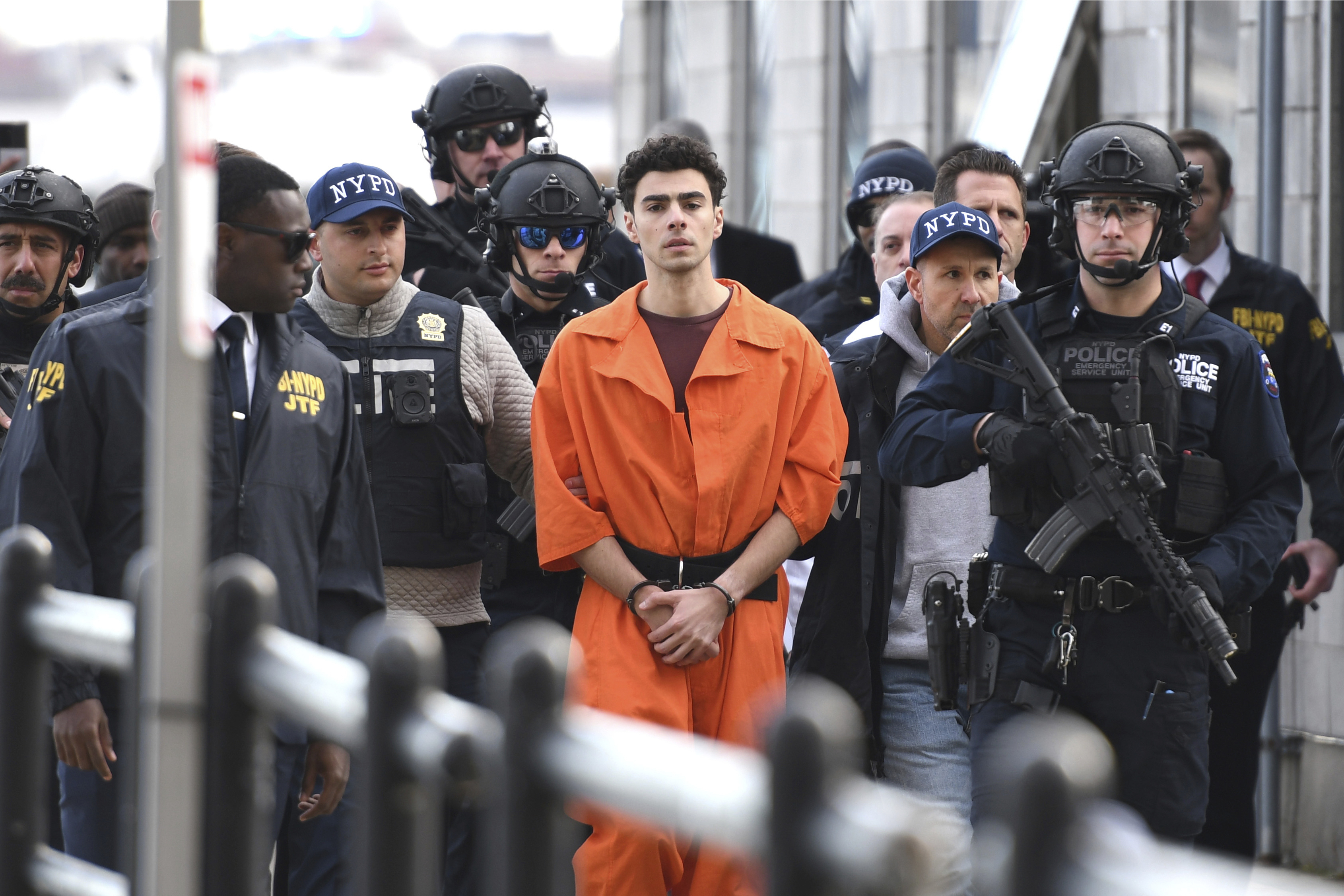 Luigi Mangione, charged with the fatal shooting of UnitedHealthcare CEO Brian Thompson, is escorted by police in New York, Dec. 19, 2024. (AP Photo/Pamela Smith)