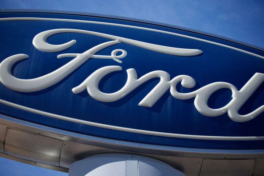 FILE - The Ford company logo is seen, Oct. 24, 2021, on a sign at a Ford dealership in southeast Denver. (AP Photo/David Zalubowski, File)