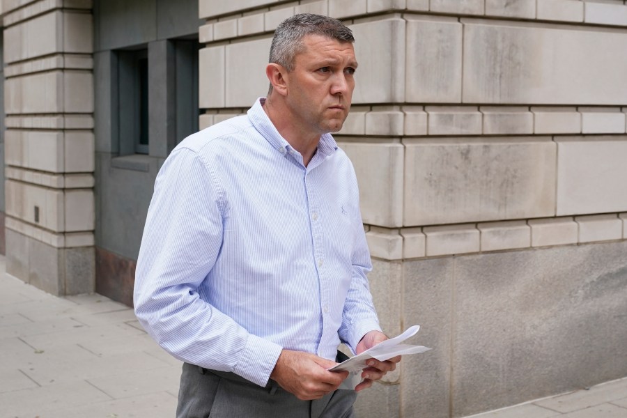 FILE - Washington Metropolitan Police Department Lt. Shane Lamond departs federal court after pleading not guilty to obstruction of justice and other charges, May 19, 2023, in Washington. A trial is underway for a police officer charged with leaking confidential information to Proud Boys leader Enrique Tarrio after the extremist group's members burned a stolen Black Lives Matter banner in the nation's capital. (AP Photo/Patrick Semansky, File)