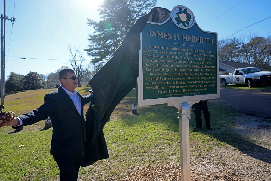 Kosciusko, Miss., Mayor Tim Kyle, unveils a Mississippi Department of Archives and History marker recognizing the birthplace and civil rights movement legacy of James Meredith, who became the first Black student to enroll at the University of Mississippi in 1962, Friday, Dec. 20, 2024, in Kosciusko, Miss. (AP Photo/Rogelio V. Solis)