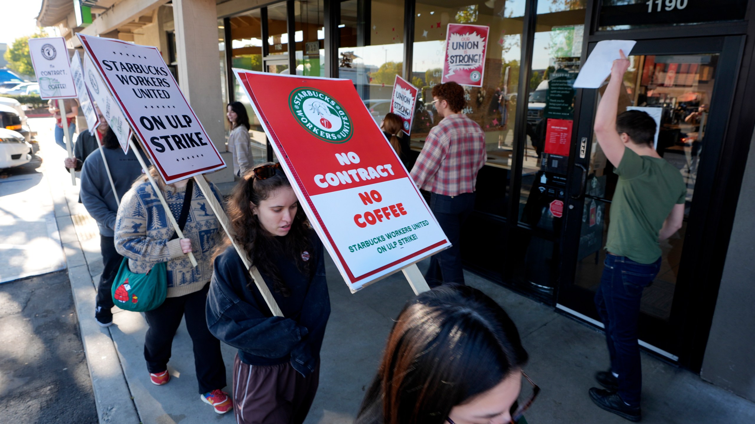 Starbuck workers picket outside of a closed Starbucks on Friday, Dec. 20, 2024, in Burbank, Calif. (AP Photo/Damian Dovarganes)