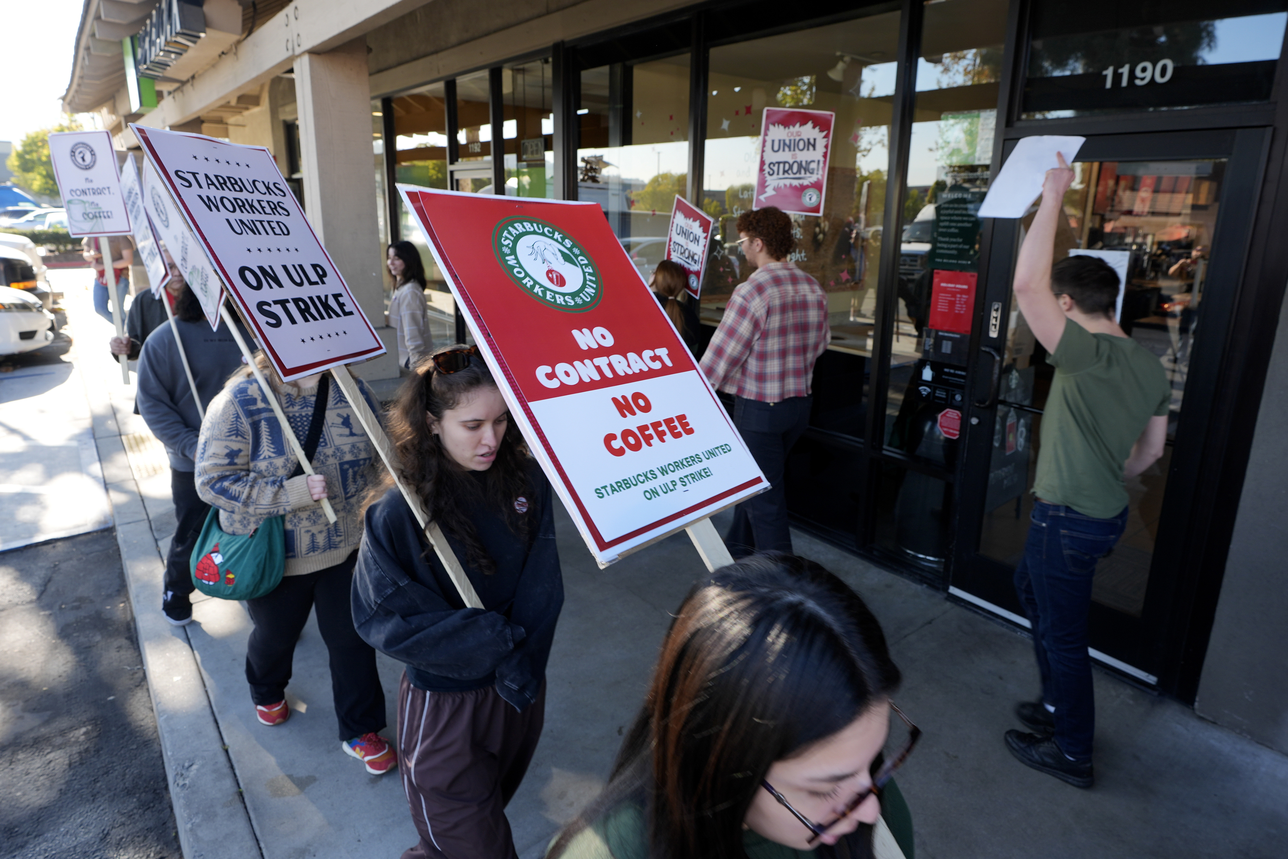 Starbuck workers picket outside of a closed Starbucks on Friday, Dec. 20, 2024, in Burbank, Calif. (AP Photo/Damian Dovarganes)