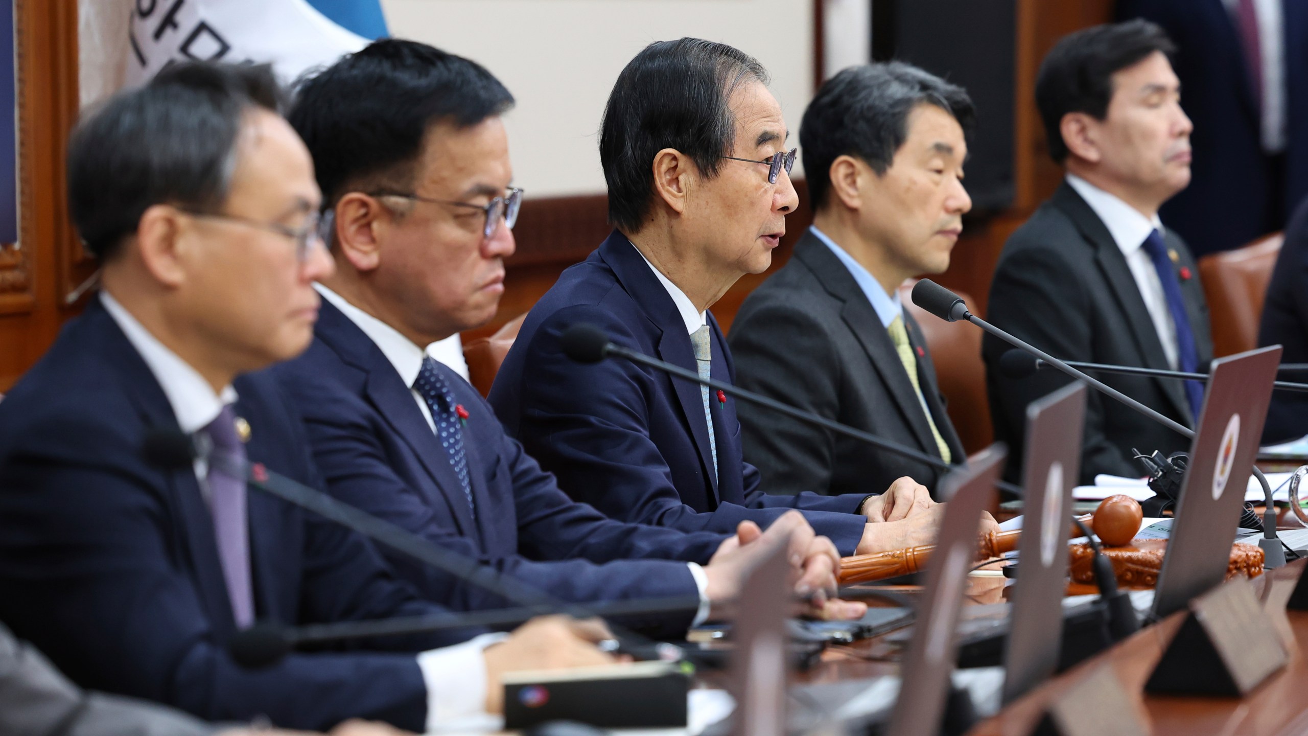 South Korea's Prime Minister Han Duck-soo, center, who became the country's acting leader after President Yoon Suk Yeol's impeachment, speaks during a cabinet meeting at the government complex in Seoul, South Korea, Tuesday, Dec. 24, 2024. (Yonhap via AP)