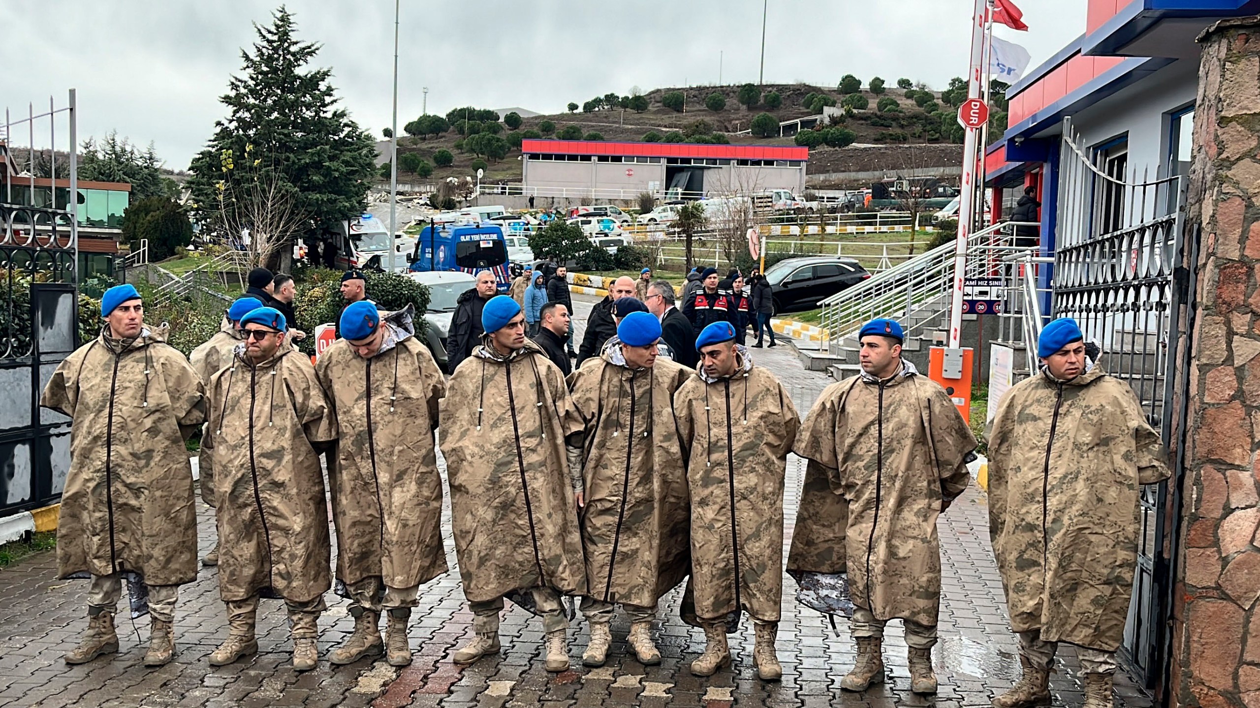 Turkish security forces stand guard next to parked ambulances at the entrance of an armament factory following an explosion that killed several people, in Balikesir, northwest Turkey, Tuesday, Dec. 24, 2024. (IHA via AP)