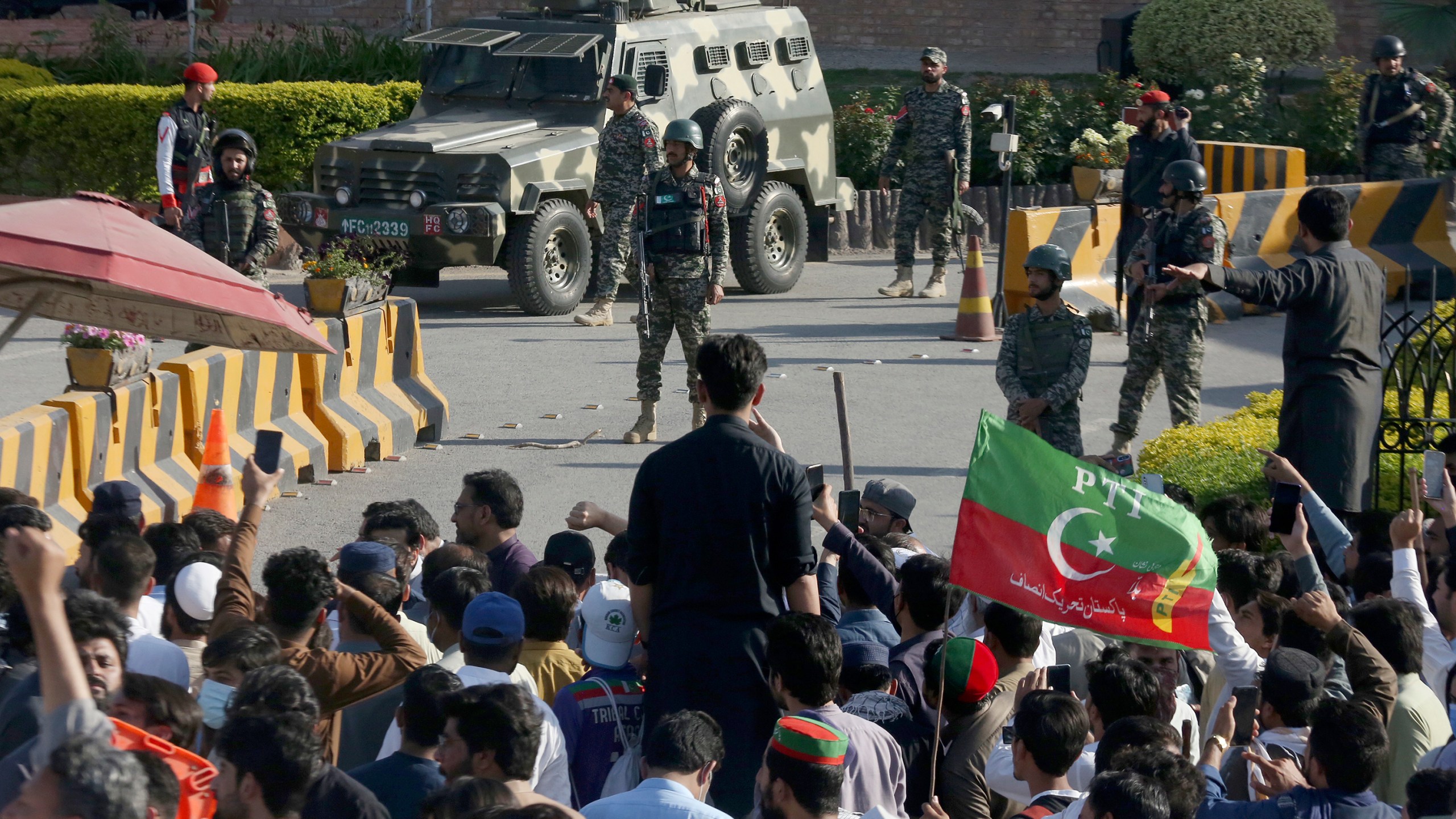 FILE - Paramilitary soldiers from Frontier Corps stand guard outside their headquarters, where supporters of Pakistan's former Prime Minister Imran Khan protest against the arrest of their leader, in Peshawar, Pakistan, Tuesday, May 9, 2023. (AP Photo/Muhammad Sajjad, File)