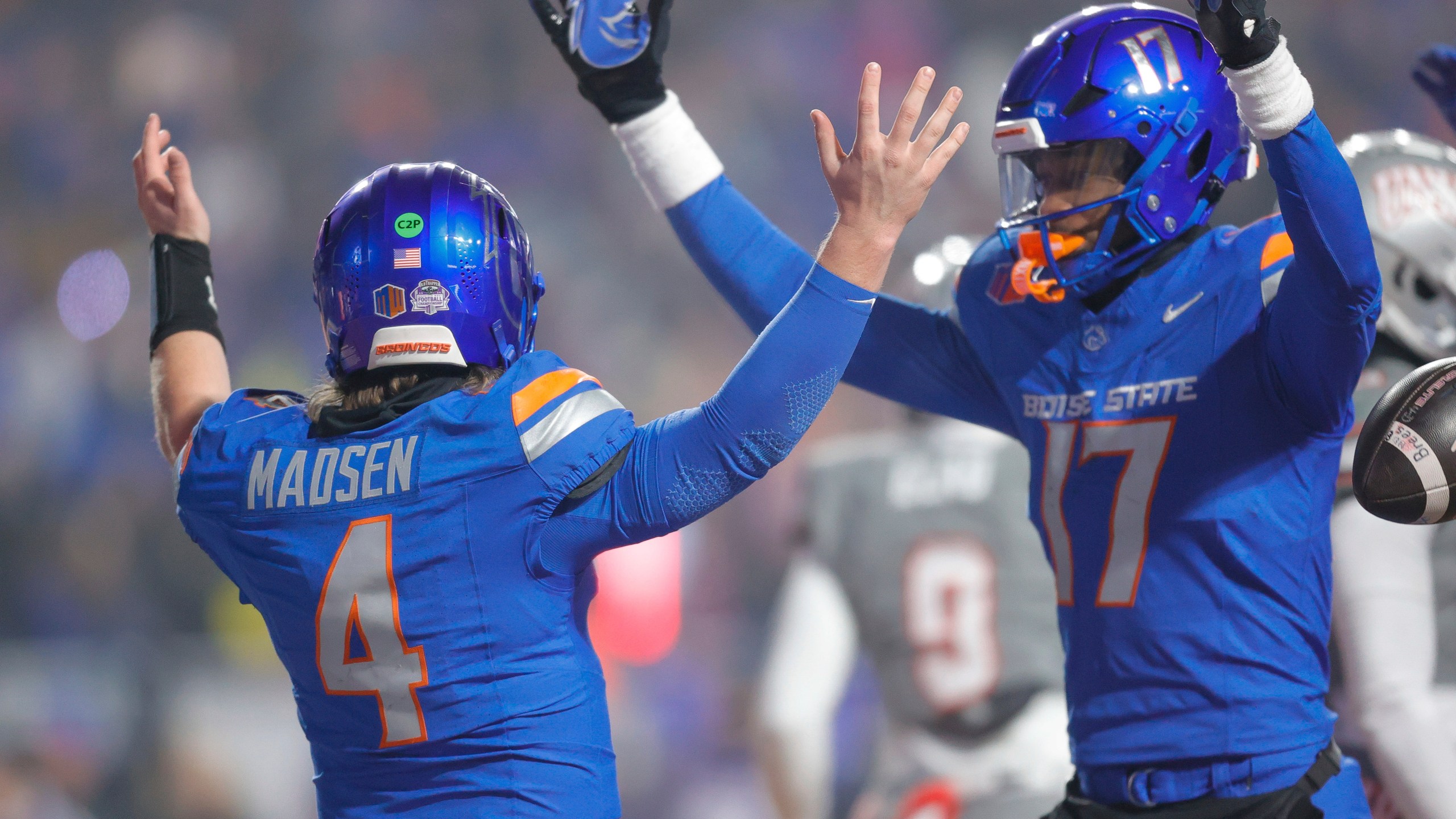 Boise State quarterback Maddux Madsen (4) celebrates after a touchdown run against UNLV with wide receiver Prince Strachan (17) late in the first half of the Mountain West Championship NCAA college football game Friday, Dec. 6, 2024, in Boise, Idaho. (AP Photo/Steve Conner)