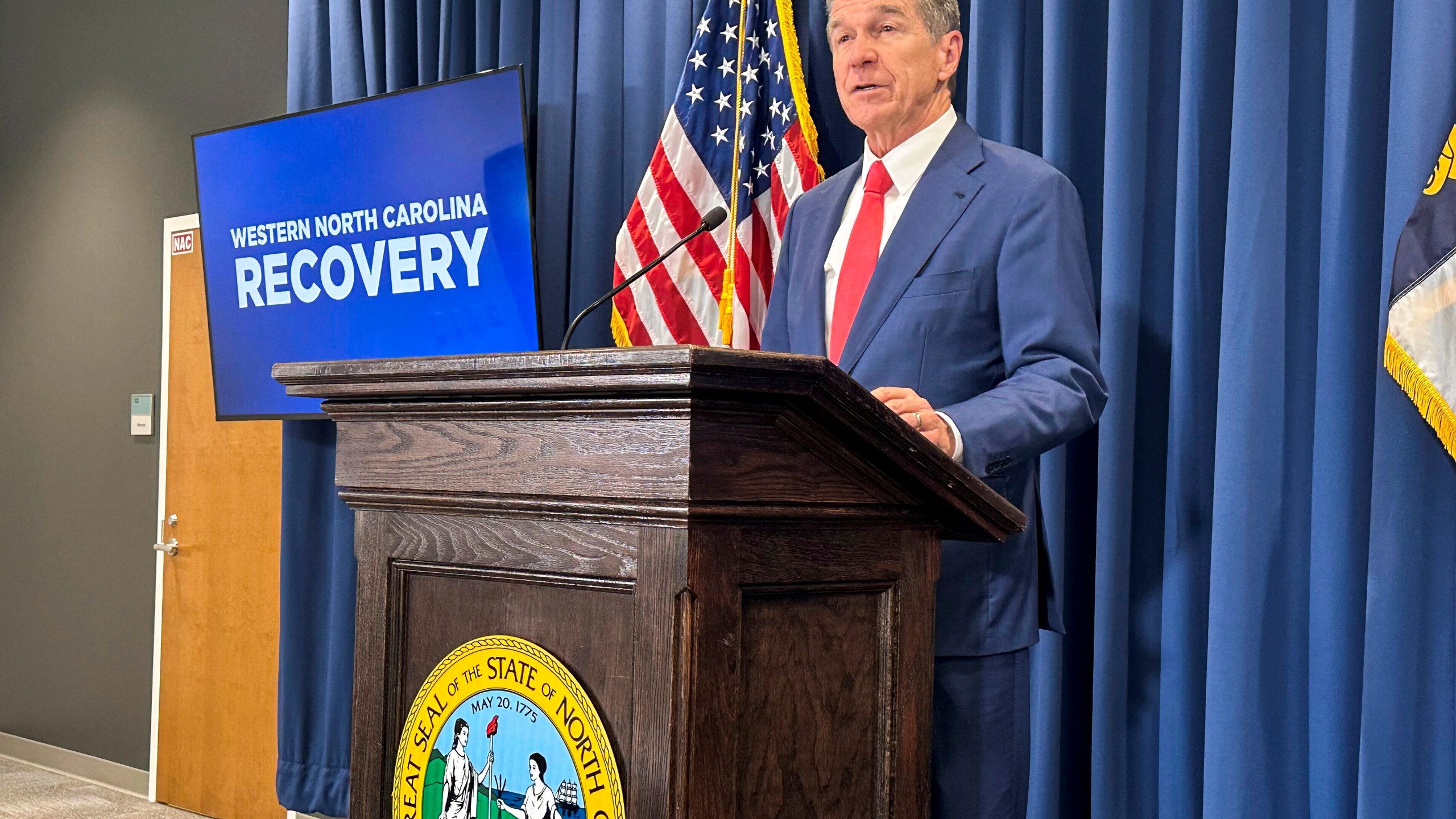 FILE - North Carolina Gov. Roy Cooper unveils a report during a press conference in Raleigh, N.C., Oct. 23, 2024. (AP Photo/Gary D. Robertson, File)