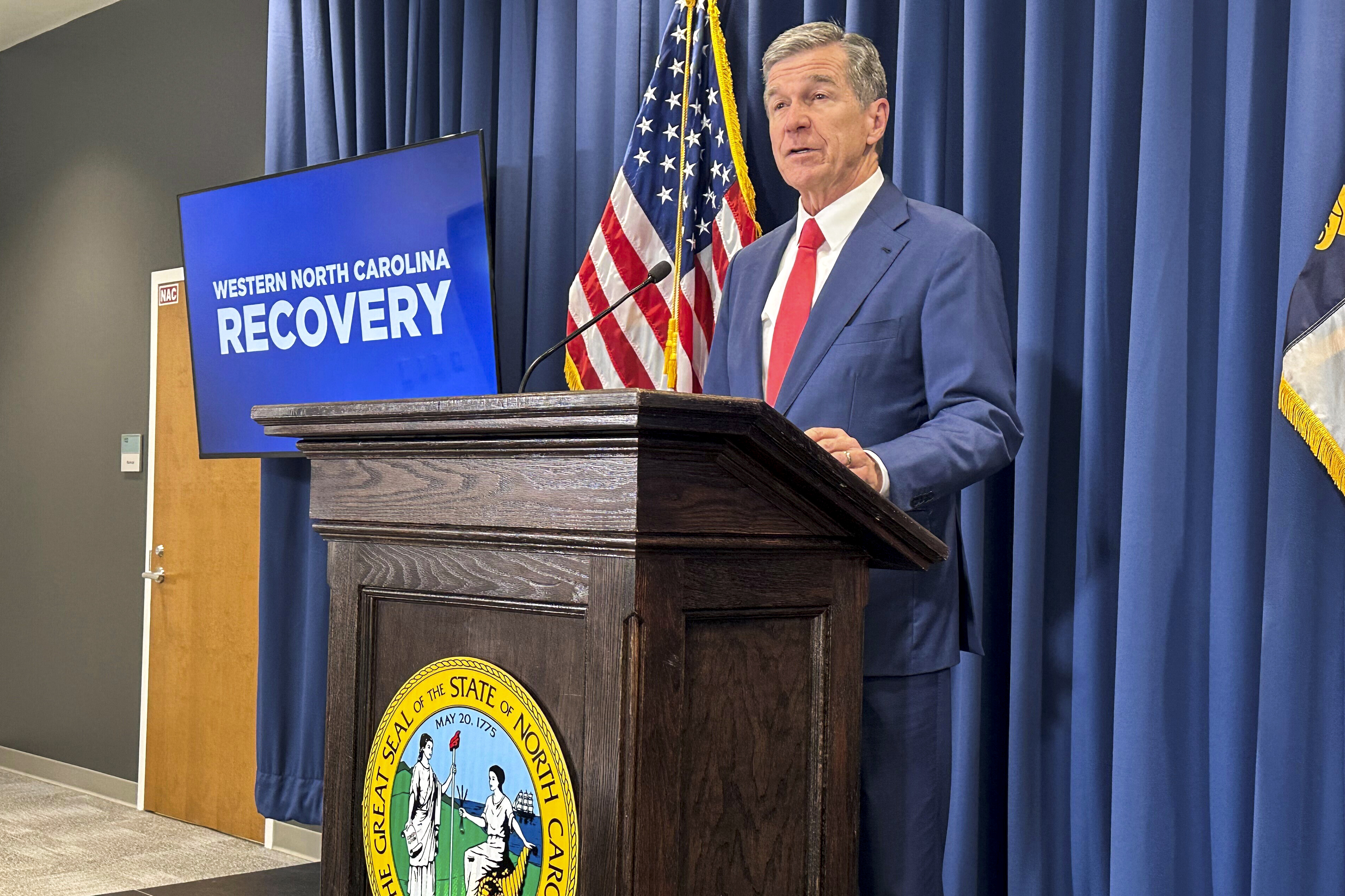 FILE - North Carolina Gov. Roy Cooper unveils a report during a press conference in Raleigh, N.C., Oct. 23, 2024. (AP Photo/Gary D. Robertson, File)