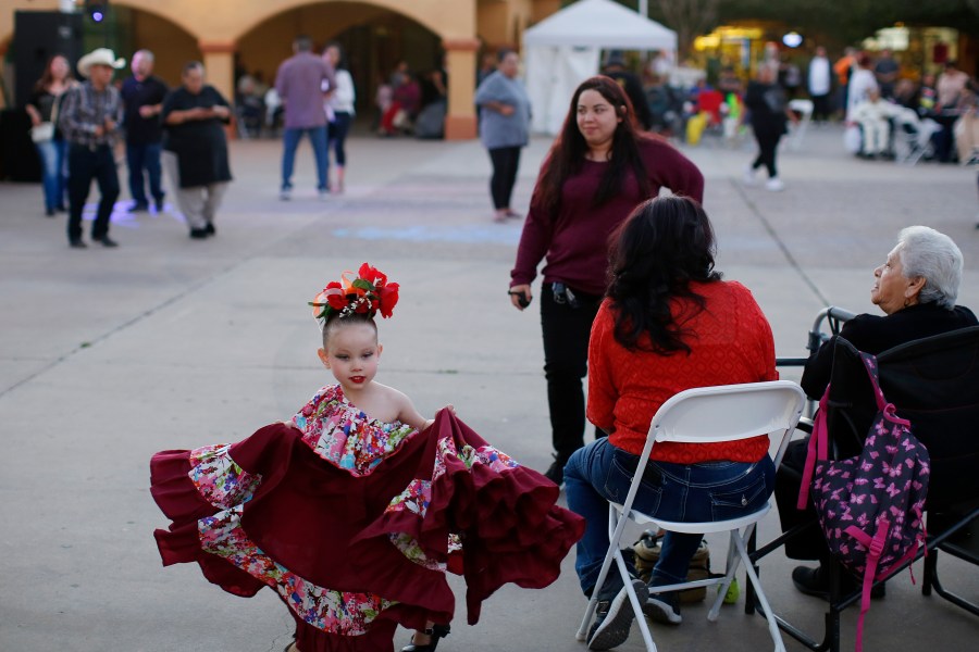 FILE - People gather in Guadalupe, Ariz., during the celebration of the town's 45th year since it was incorporated, on Feb. 8, 2020. (AP Photo/Dario Lopez-MIlls, File)