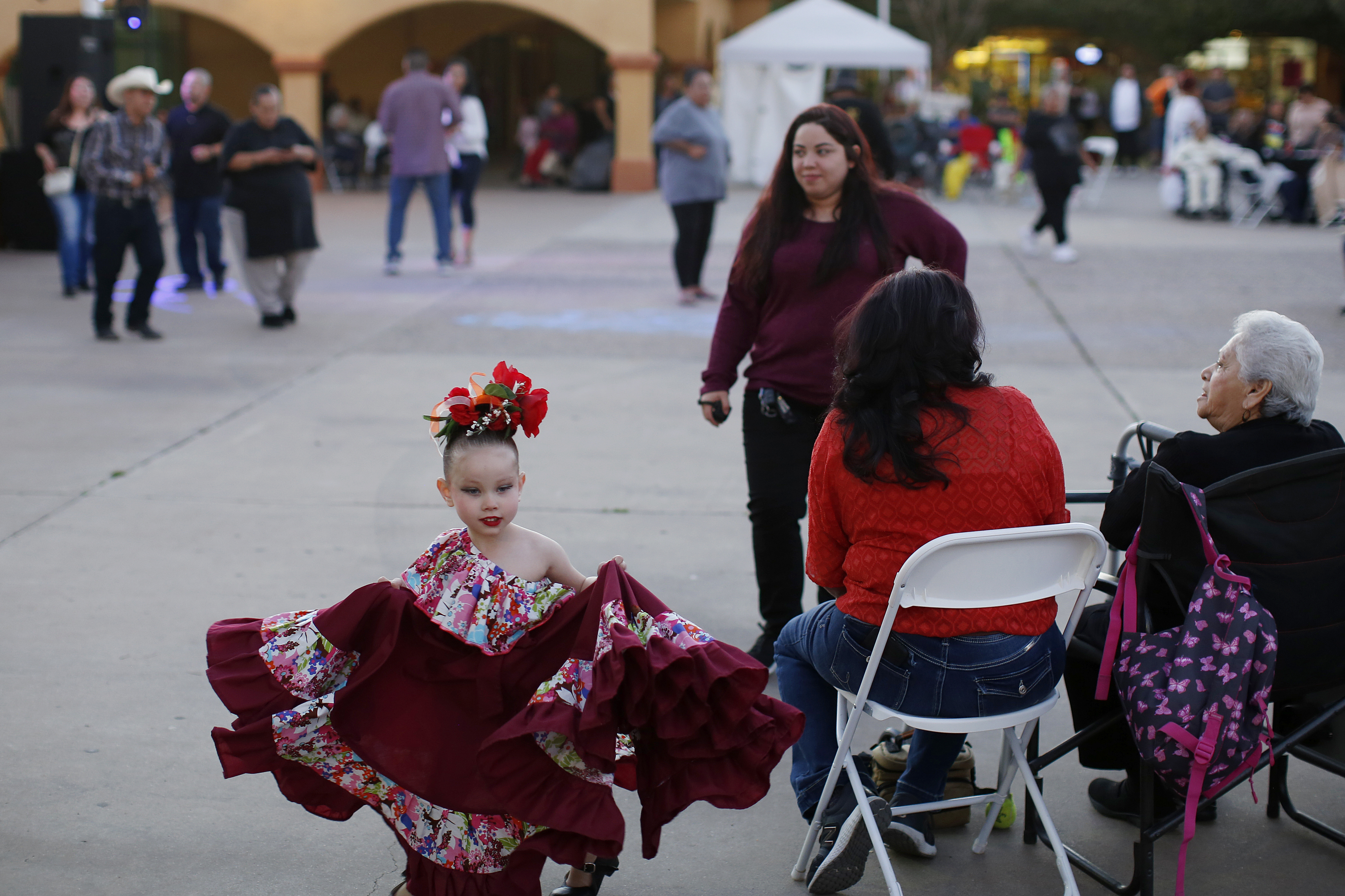 FILE - People gather in Guadalupe, Ariz., during the celebration of the town's 45th year since it was incorporated, on Feb. 8, 2020. (AP Photo/Dario Lopez-MIlls, File)