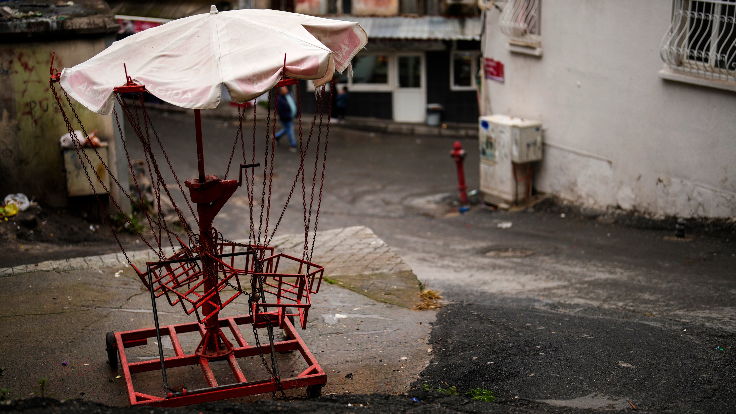 A manually operated carousel is seen in the Tarlabasi neighborhood in Istanbul, Turkey, Wednesday, Dec. 4, 2024. (AP Photo/Francisco Seco)