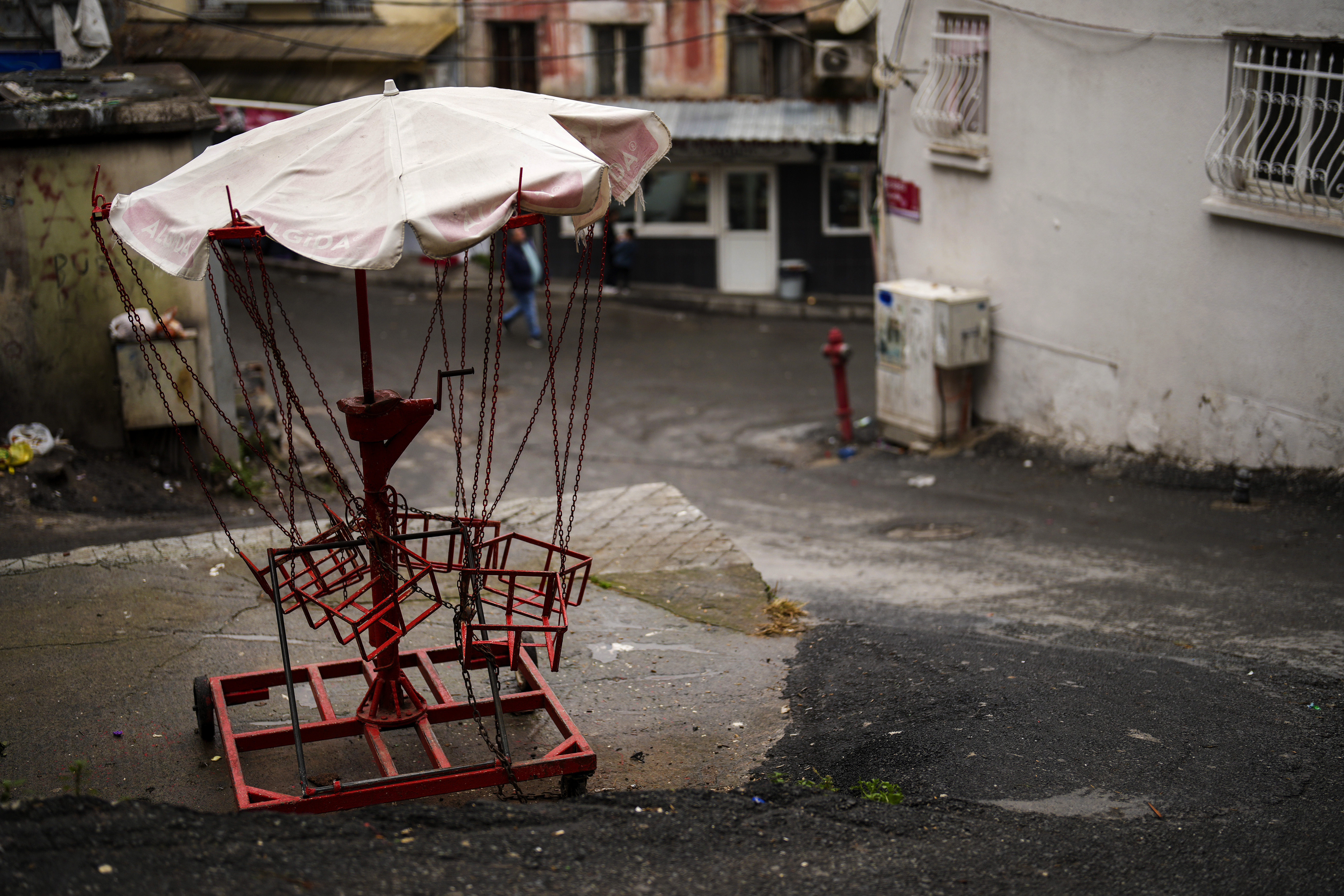 A manually operated carousel is seen in the Tarlabasi neighborhood in Istanbul, Turkey, Wednesday, Dec. 4, 2024. (AP Photo/Francisco Seco)