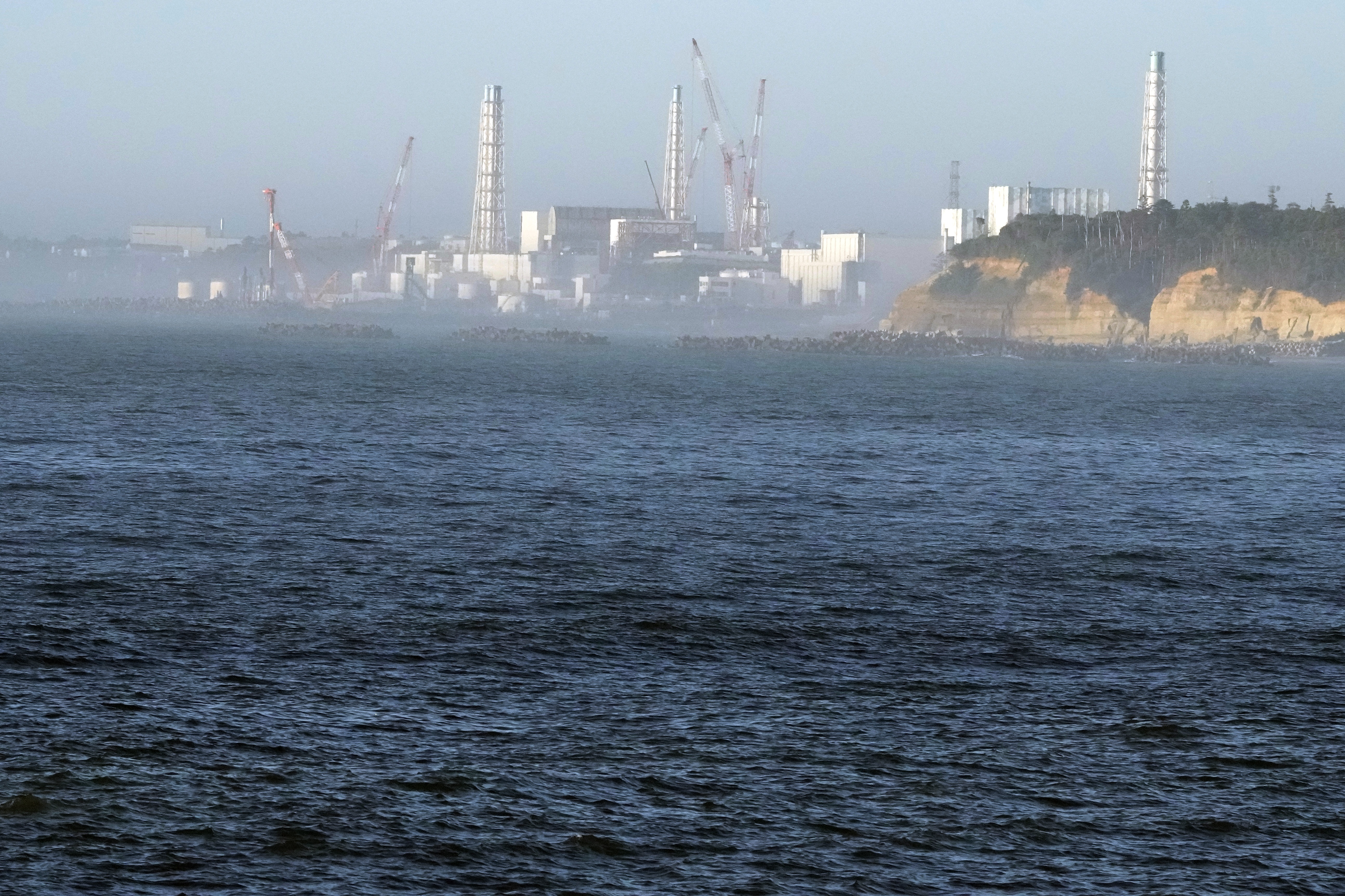 FILE - The Fukushima Daiichi nuclear power plant, damaged by a massive March 11, 2011, earthquake and tsunami, is seen from the nearby Ukedo fishing port in Namie town, northeastern Japan, Thursday, Aug. 24, 2023. (AP Photo/Eugene Hoshiko, File)