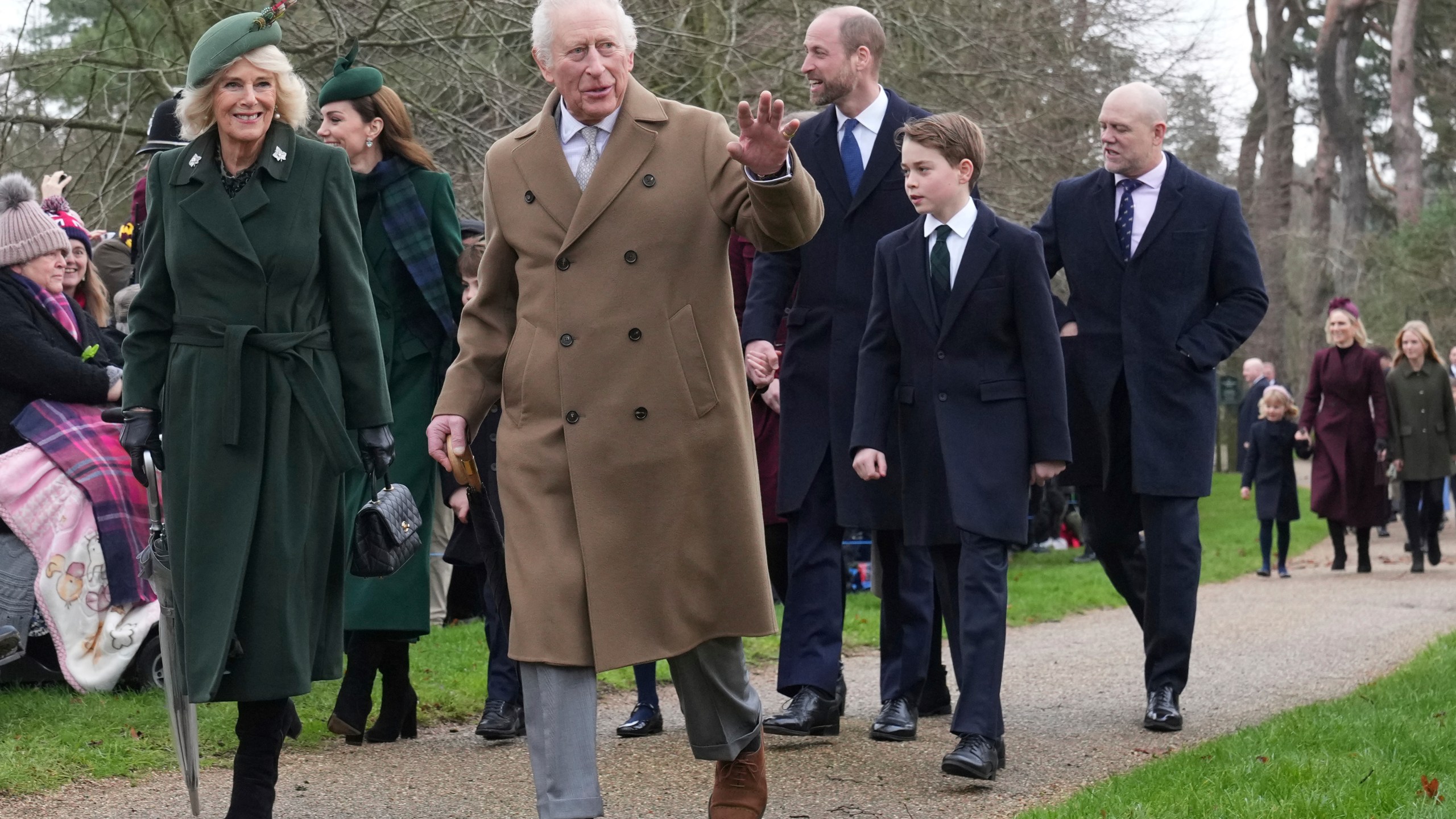 Britain's King Charles III waves to the crowd as he and Queen Camilla, Prince William, Prince George attend the Christmas day service at St Mary Magdalene Church in Sandringham in Norfolk, England, Wednesday, Dec. 25, 2024. (AP Photo/Jon Super)