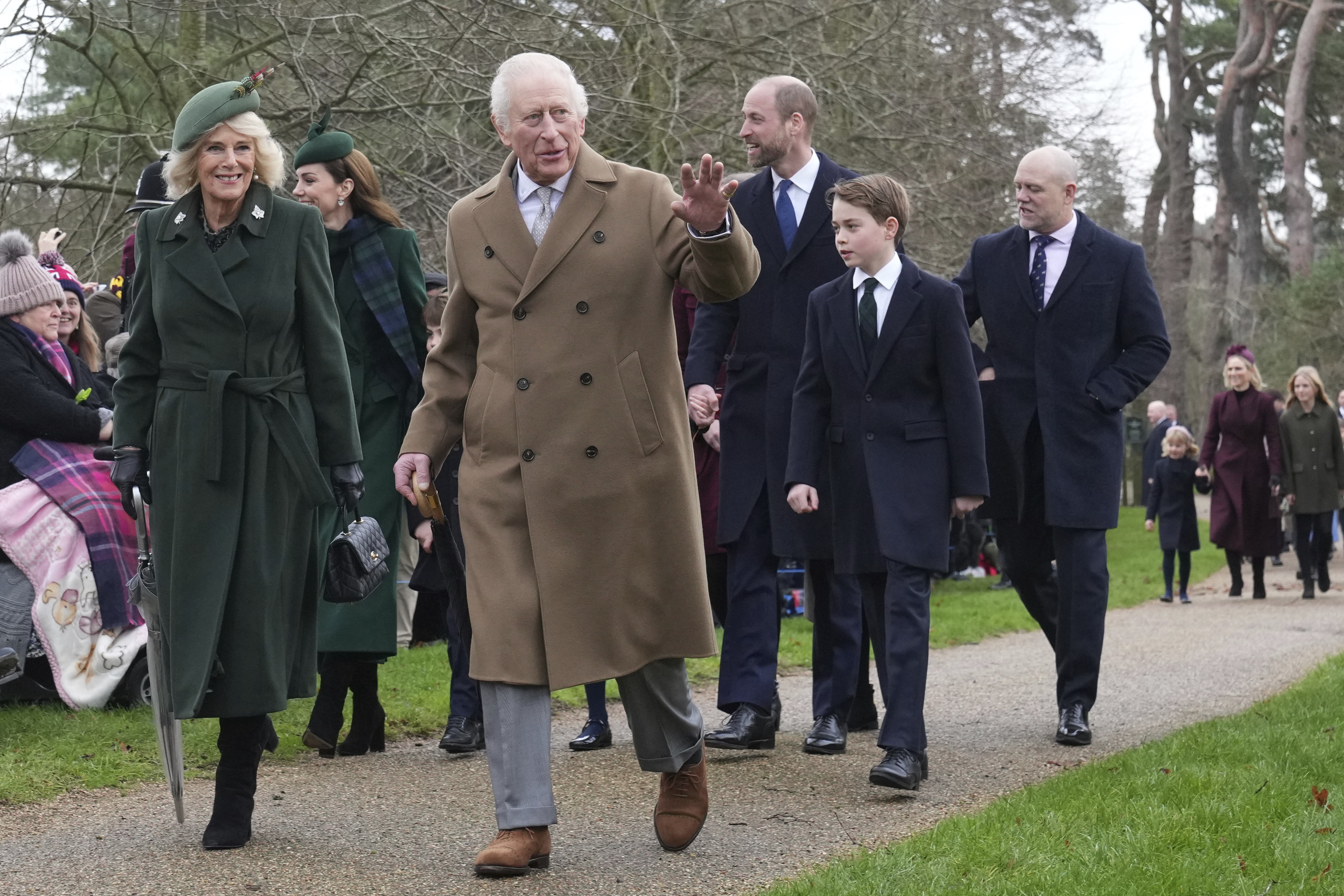 Britain's King Charles III waves to the crowd as he and Queen Camilla, Prince William, Prince George attend the Christmas day service at St Mary Magdalene Church in Sandringham in Norfolk, England, Wednesday, Dec. 25, 2024. (AP Photo/Jon Super)