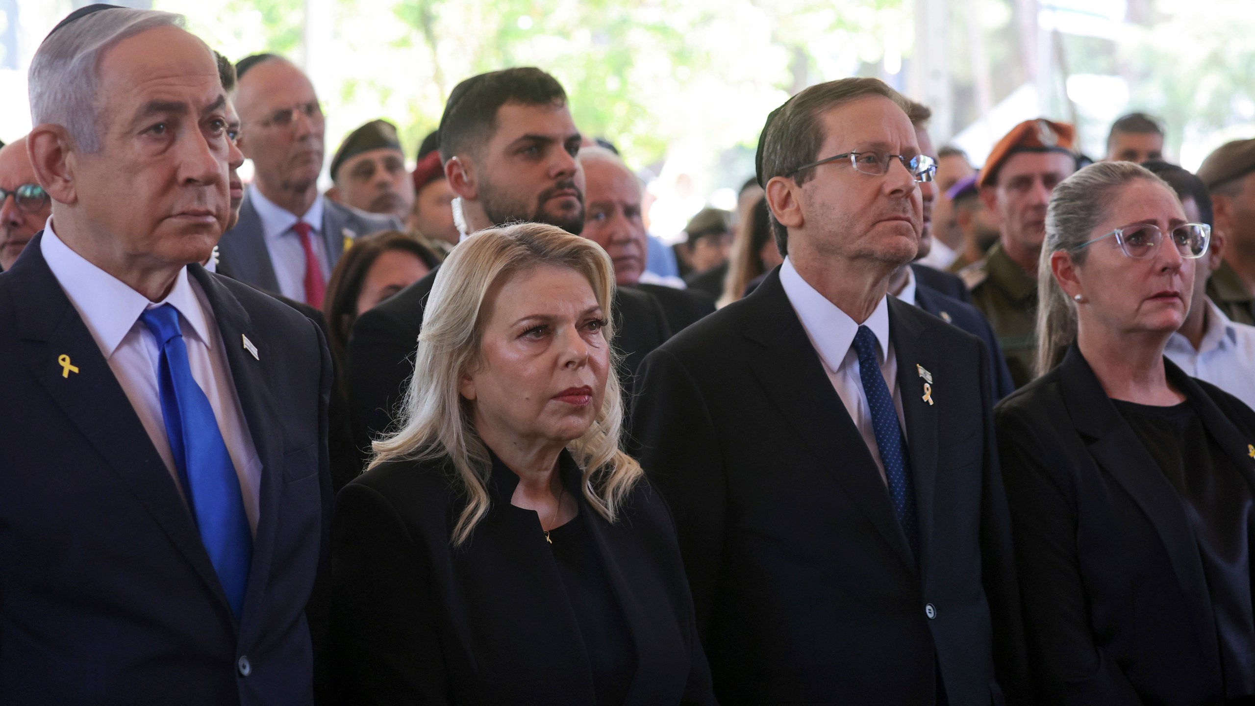 FILE - Israel's Prime Minister Benjamin Netanyahu, from left, his wife Sara Netanyahu, President Isaac Herzog and First Lady Michal Herzog, attend a ceremony marking the Hebrew calendar anniversary of the Hamas attack on October 7 2023 that sparked the ongoing war in Gaza, at the Mount Herzl military cemetery in Jerusalem, Israel, Oct. 27, 2024. (Gil Cohen-Magen/Pool Photo via AP, File)