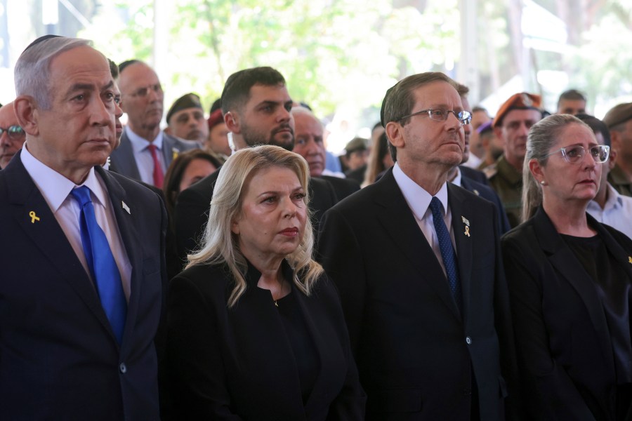 FILE - Israel's Prime Minister Benjamin Netanyahu, from left, his wife Sara Netanyahu, President Isaac Herzog and First Lady Michal Herzog, attend a ceremony marking the Hebrew calendar anniversary of the Hamas attack on October 7 2023 that sparked the ongoing war in Gaza, at the Mount Herzl military cemetery in Jerusalem, Israel, Oct. 27, 2024. (Gil Cohen-Magen/Pool Photo via AP, File)