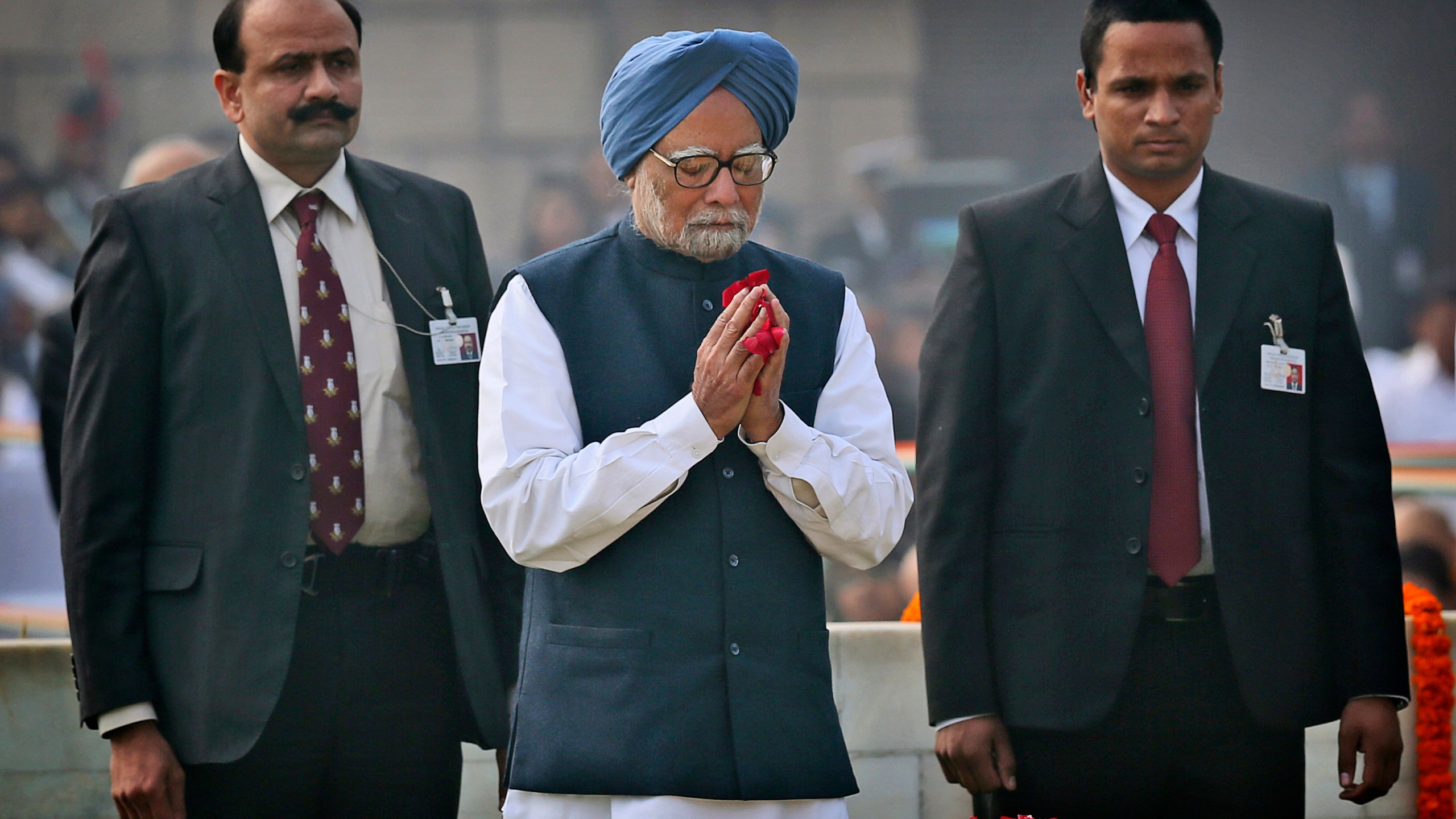 FILE - Indian Prime Minister Manmohan Singh, center, pays floral tributes at Rajghat, the memorial of Mahatma Gandhi, on his death anniversary in New Delhi, India, Monday, Jan. 30, 2014. (AP Photo/Manish Swarup, File)