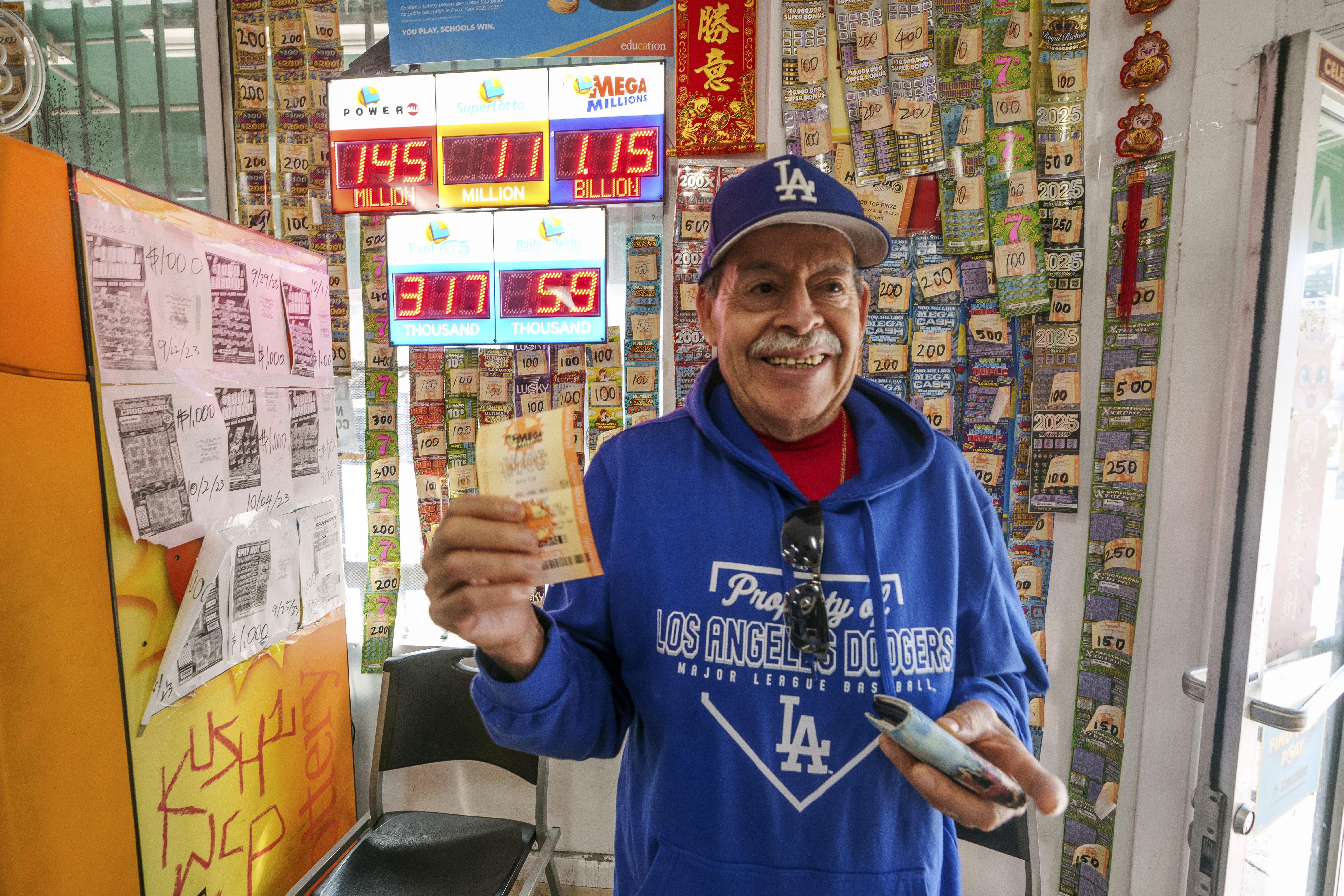 Fidel Lule buys a MegaMillion lottery ticket at Won Won Mini Mart in Chinatown Los Angeles, Thursday, Dec. 26, 2024. (AP Photo/Damian Dovarganes)