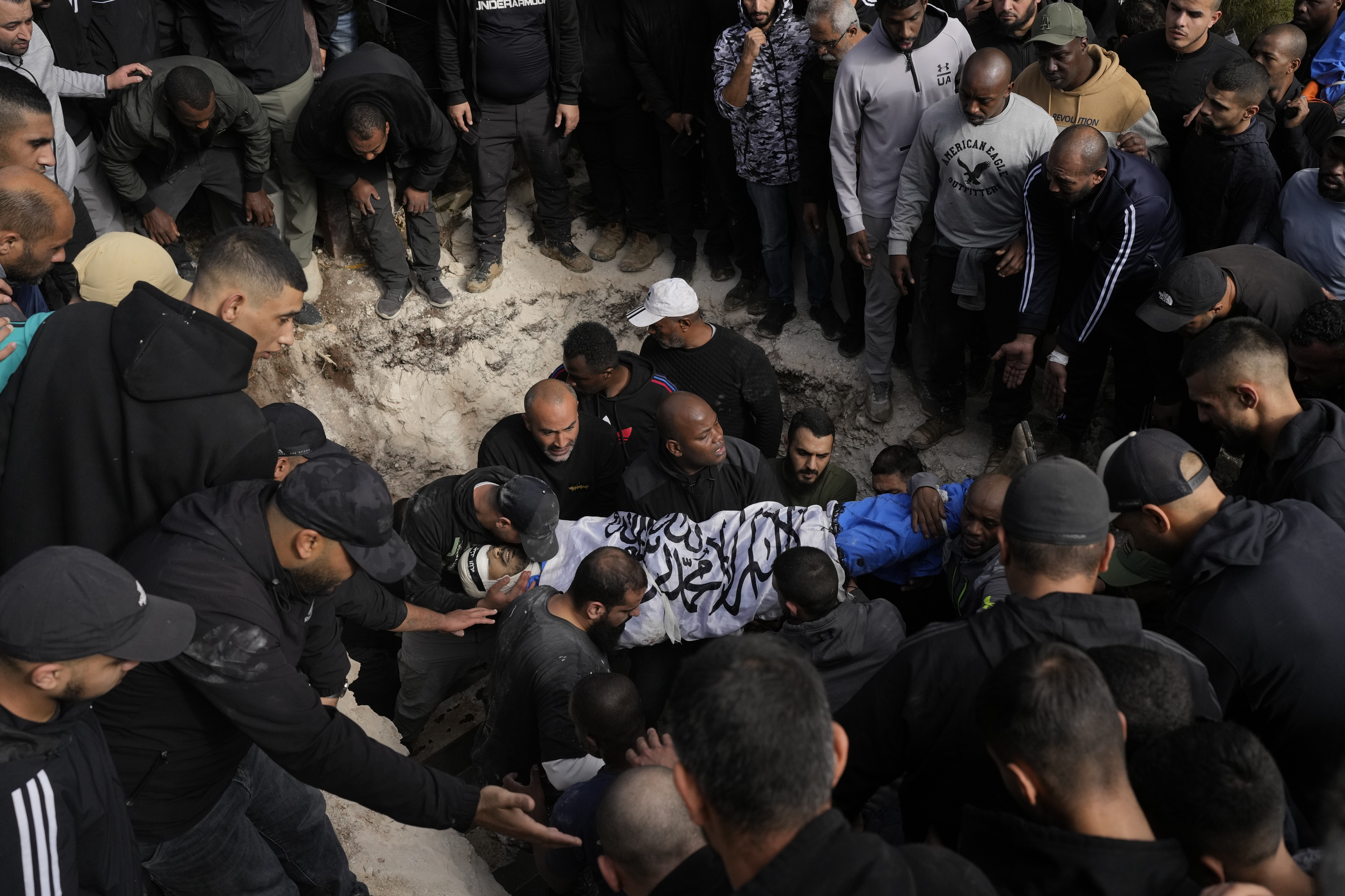 A Palestinian killed during an Israeli army operation is buried in the West Bank city of Tulkarem, Thursday, Dec. 26, 2024. (AP Photo/Matias Delacroix)