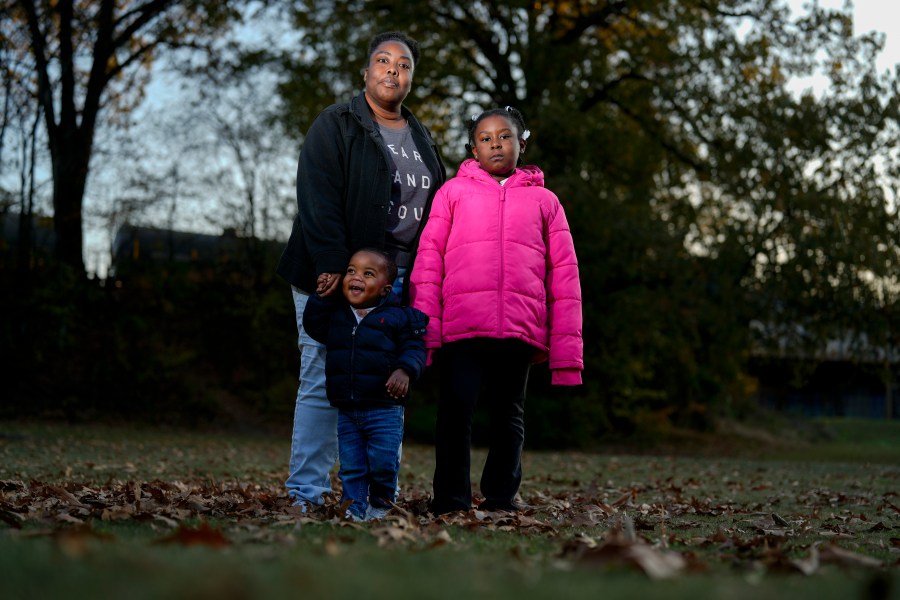 Anika Chillis stands for a photo with her children Makhi 2, and Myla 9, Monday, Dec. 2, 2024, in Memphis, Tenn. (AP Photo/George Walker IV)