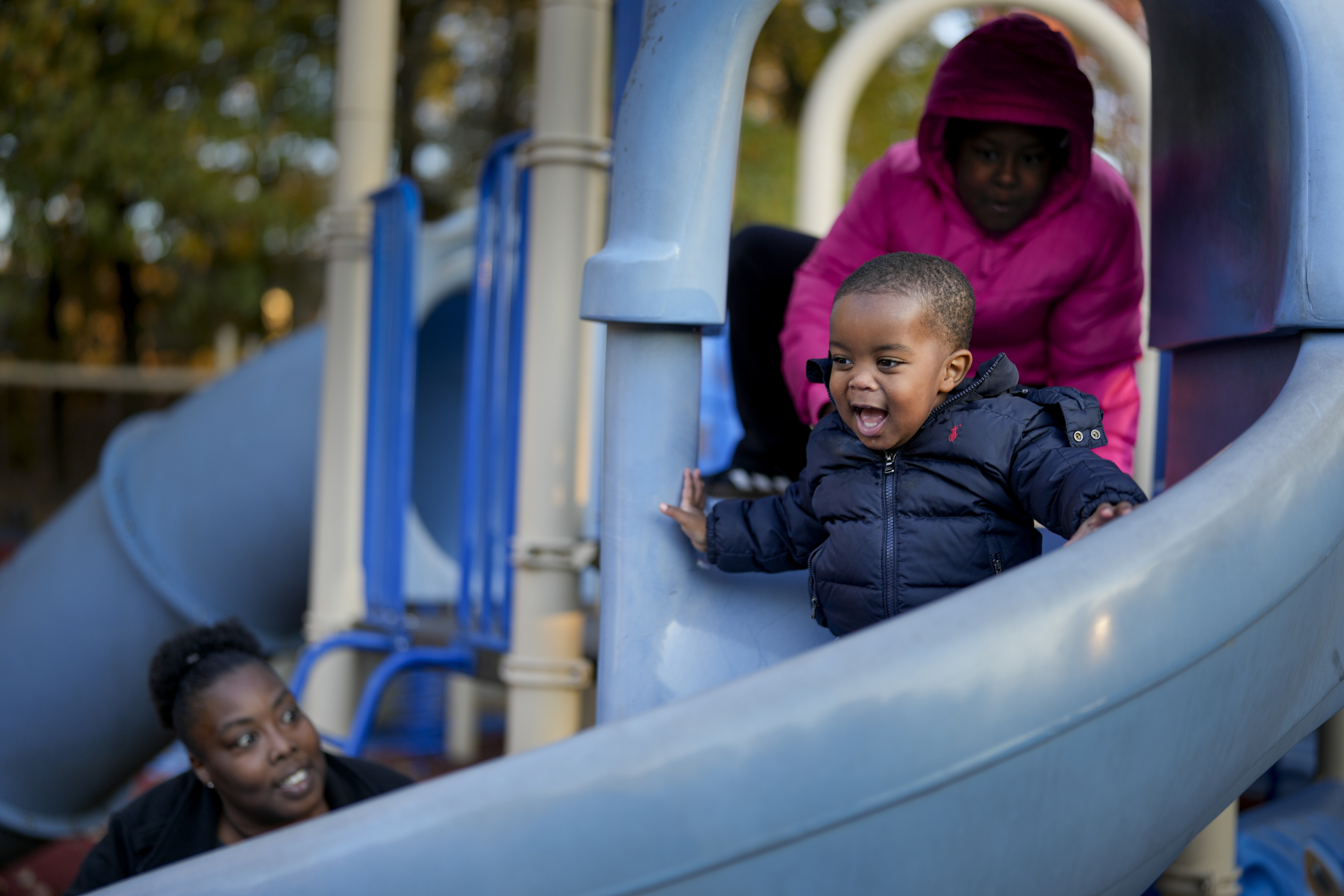 Anika Chillis, left, spends time with her children, Makhi, 2, center, and Myla 9, right, at a playground Monday, Dec. 2, 2024, in Memphis, Tenn. (AP Photo/George Walker IV)