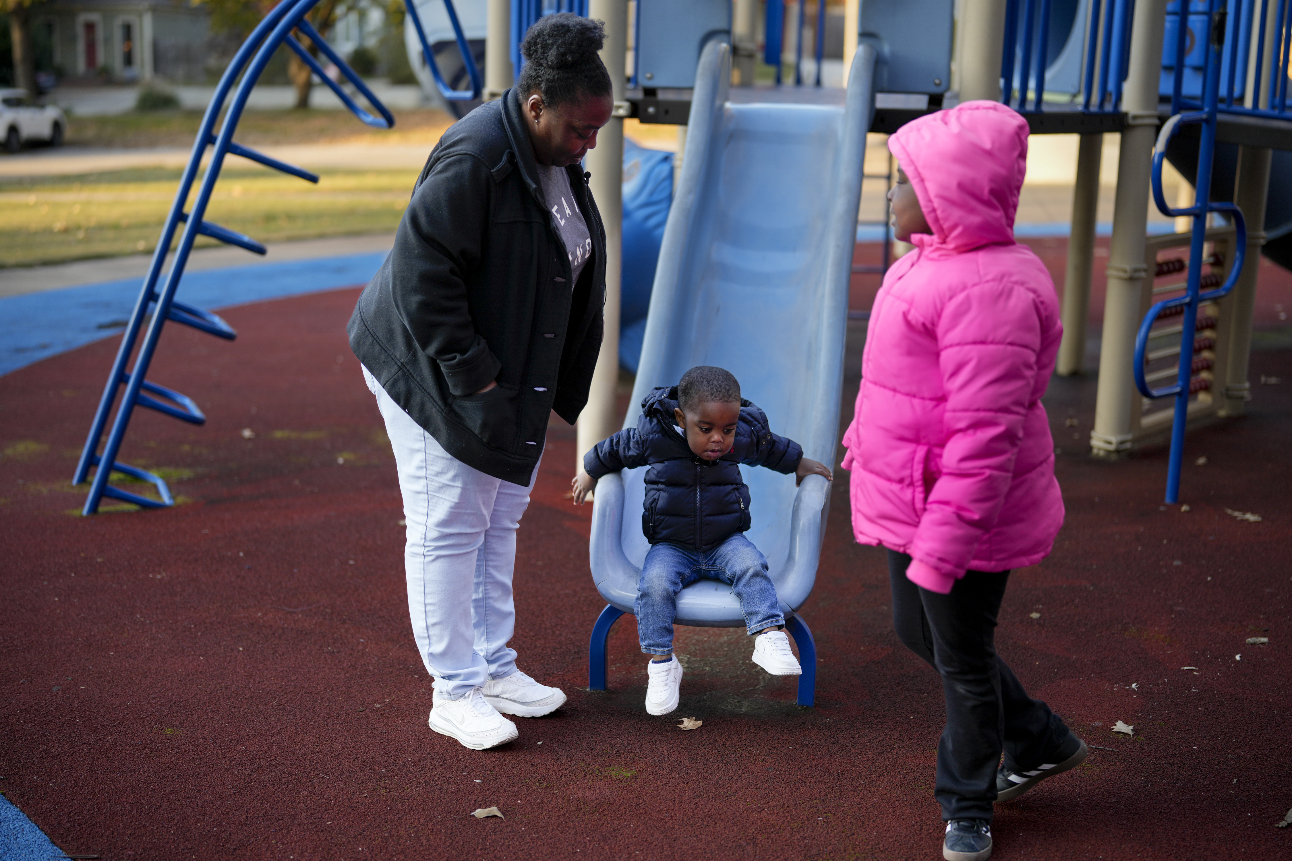 Anika Chillis spends time with her children, Makhi 2, and Myla 9, at a playground Monday, Dec. 2, 2024, in Memphis, Tenn. (AP Photo/George Walker IV)