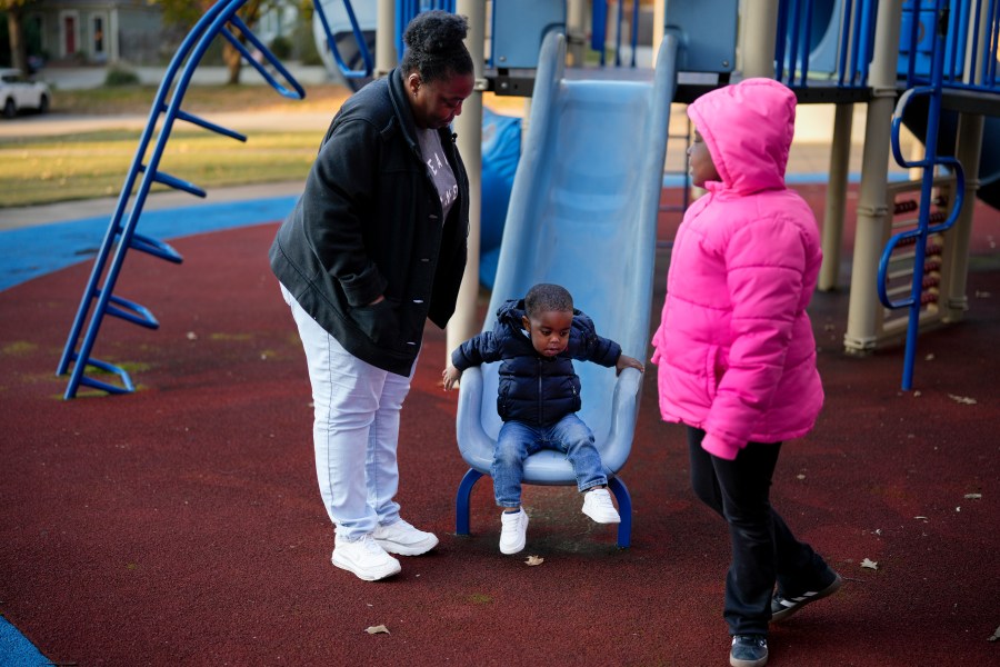 Anika Chillis spends time with her children, Makhi 2, and Myla 9, at a playground Monday, Dec. 2, 2024, in Memphis, Tenn. (AP Photo/George Walker IV)