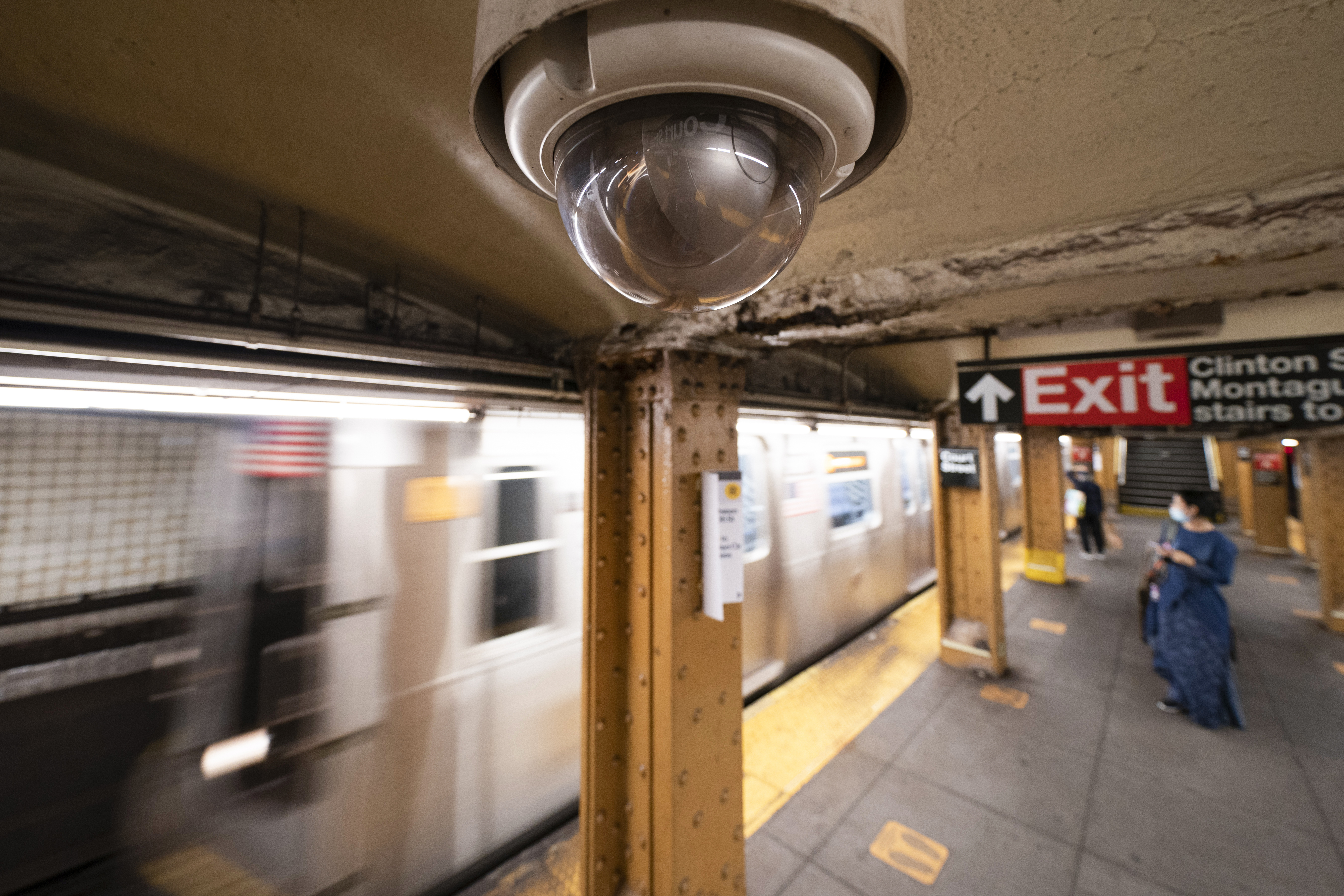 FILE - A video surveillance camera hangs from the ceiling above a subway platform, Oct. 7, 2020, in the Brooklyn borough of New York. (AP Photo/Mark Lennihan, File)