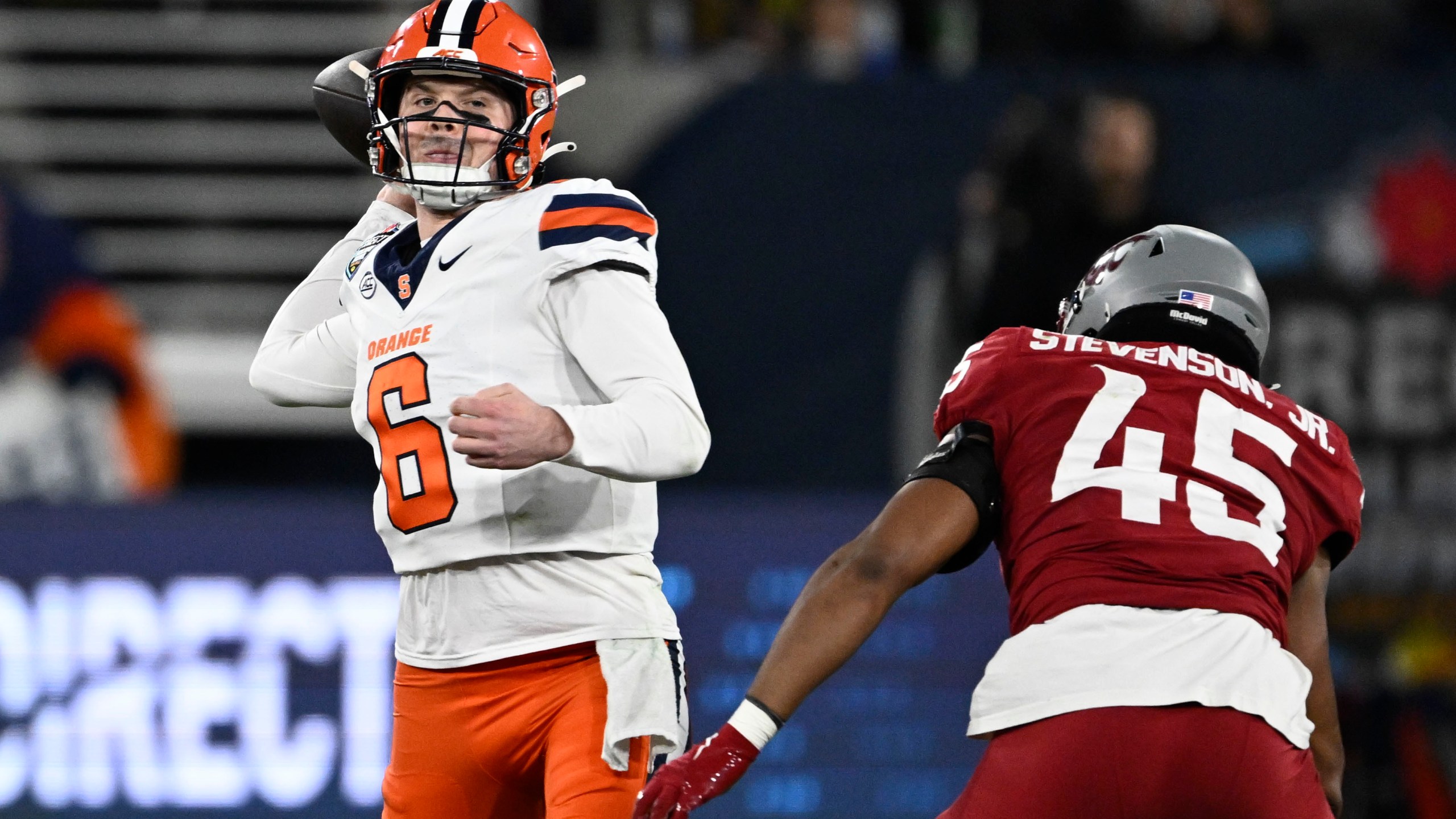 Syracuse quarterback Kyle McCord (6) passes under pressure from Washington State edge Raam Stevenson (45) during the first half of the Holiday Bowl NCAA college football game Friday, Dec. 27, 2024, in San Diego. (AP Photo/Denis Poroy)