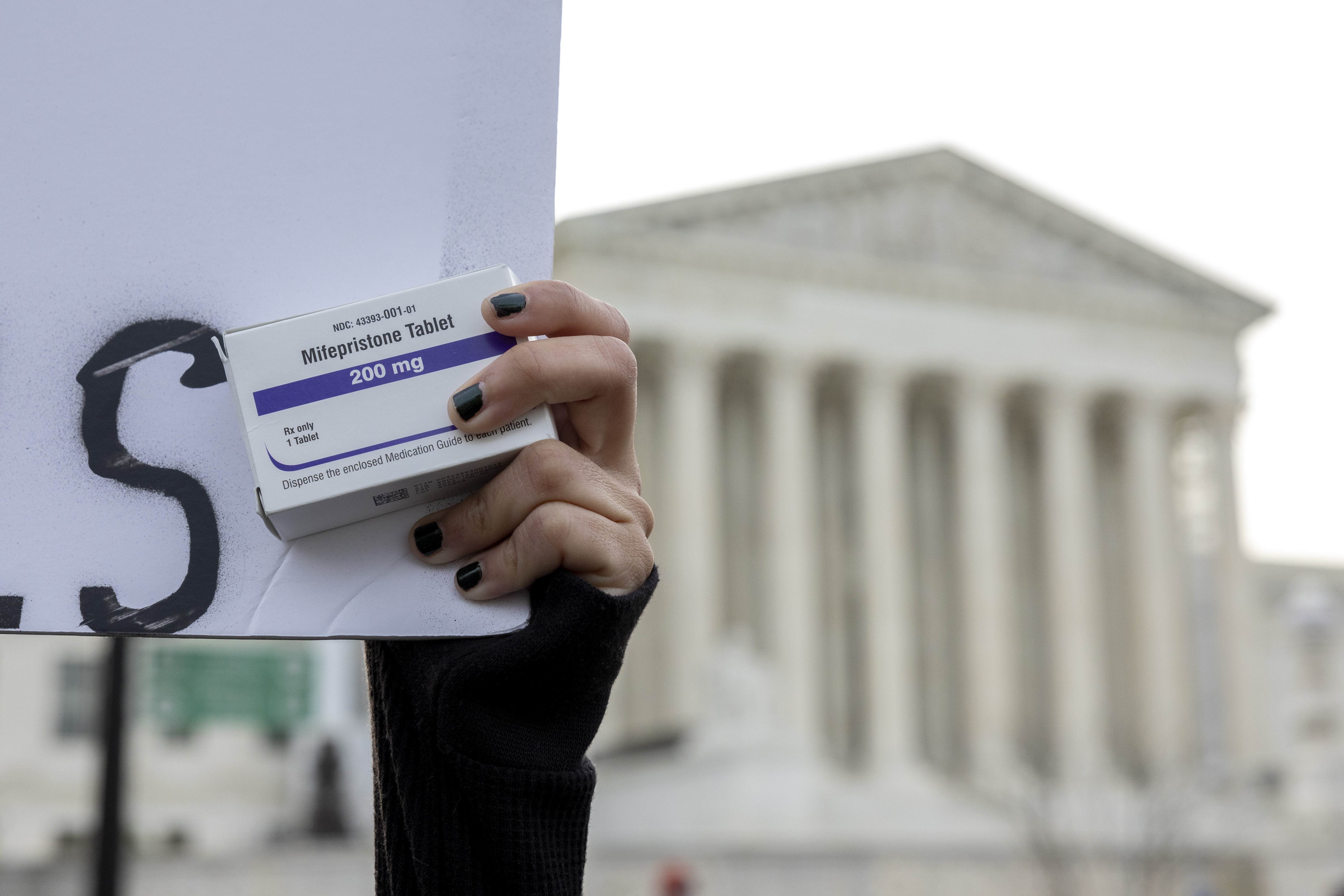 FILE - An abortion- rights activist holds a box of mifepristone pills as demonstrators from both anti-abortion and abortion-rights groups rally outside the Supreme Court in Washington, Tuesday, March 26, 2024. (AP Photo/Amanda Andrade-Rhoades, File)