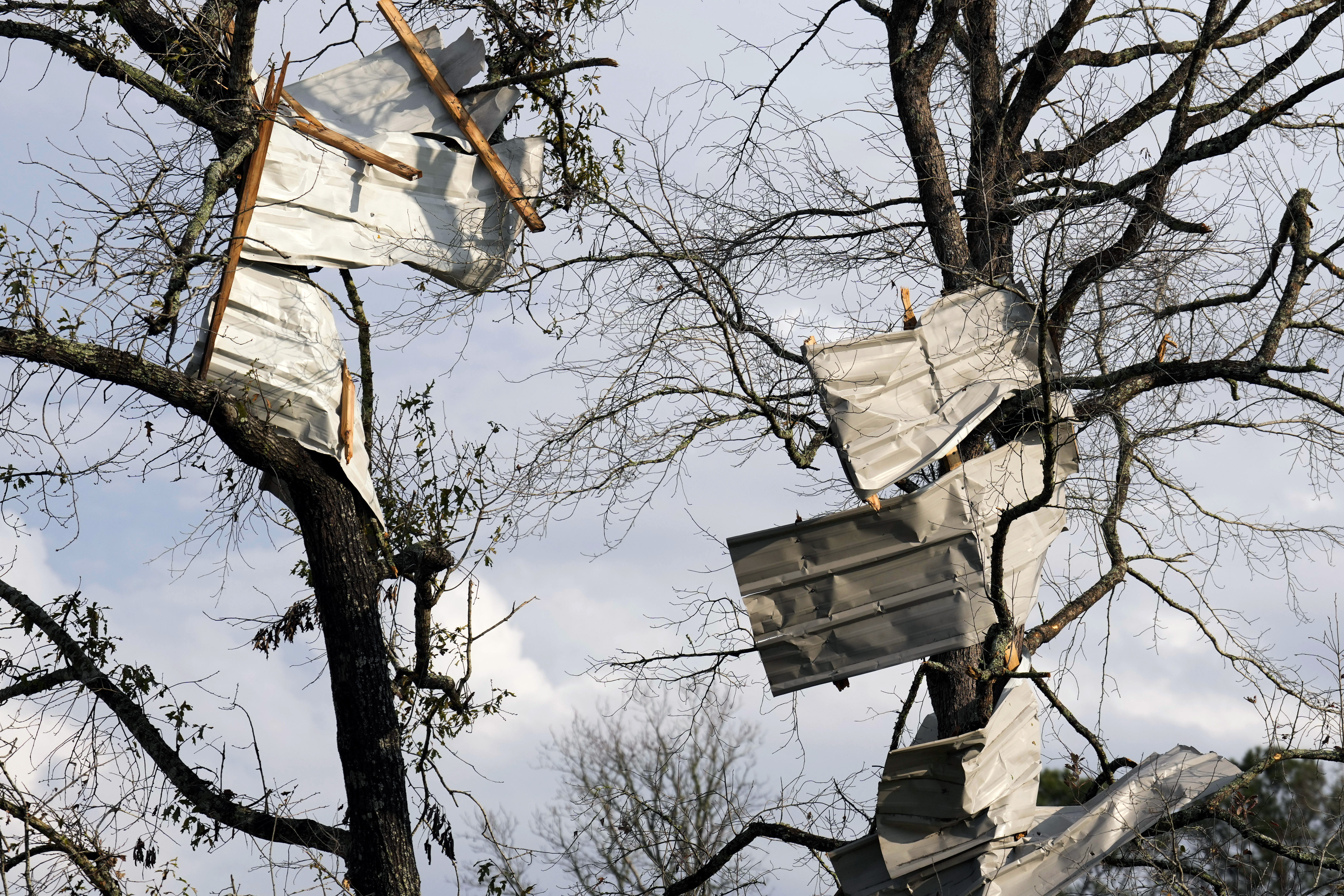 Metal roofing sheets are seen on trees after strong thunderstorms pass through the Greater Houston region, Saturday, Dec. 28, 2024, in Porter Heights. (Jason Fochtman/Houston Chronicle via AP)