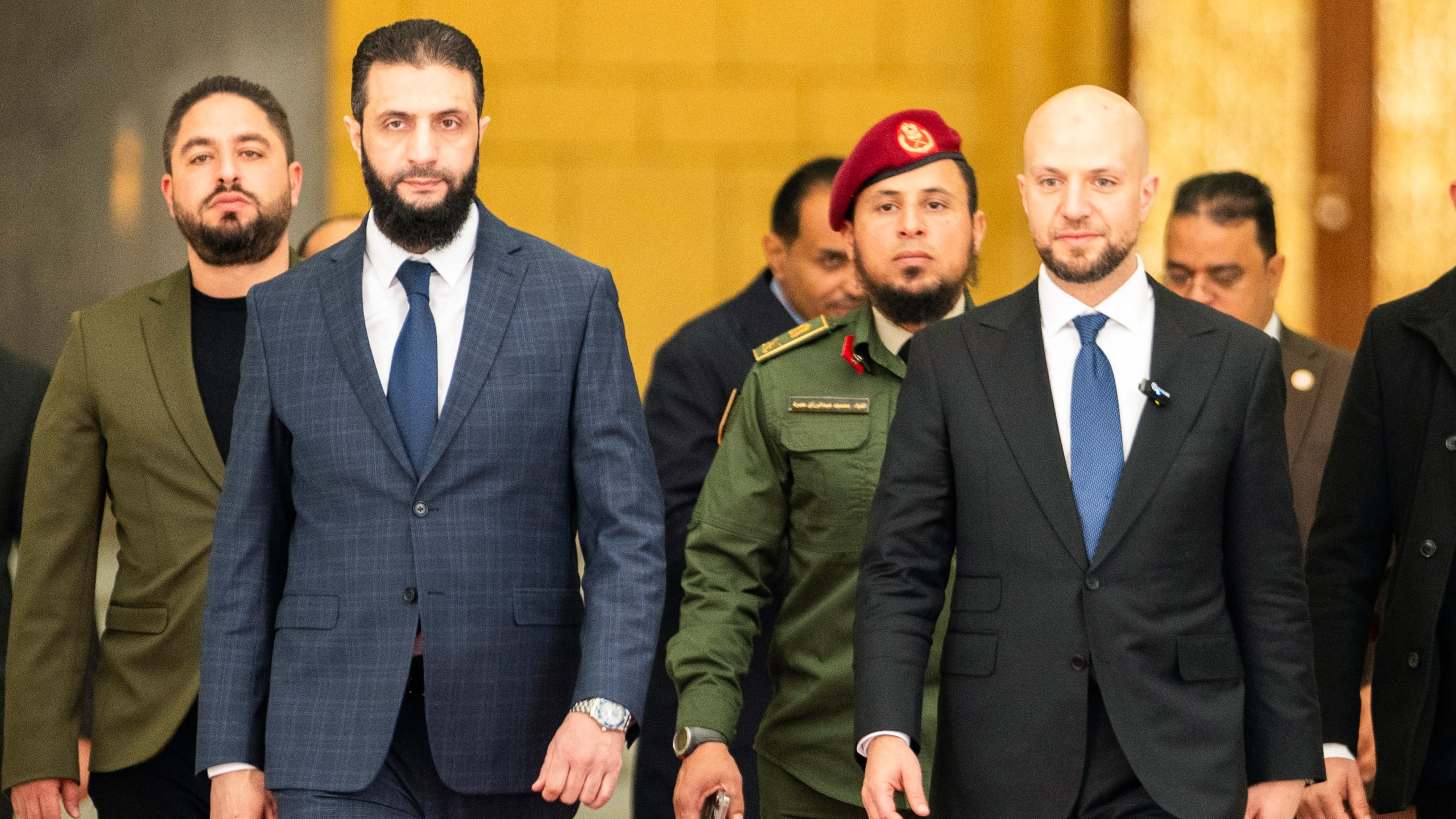 Syria's de facto leader Ahmad al-Sharaa, oreground left, formerly known as Abu Mohammed al-Golani, meets with Walid Ellafi, right, Libyan minister of state for communication and political affairs, in the presidential palace in Damascus, Syria, Saturday, Dec. 28, 2024. (AP Photo/Mosa'ab Elshamy)