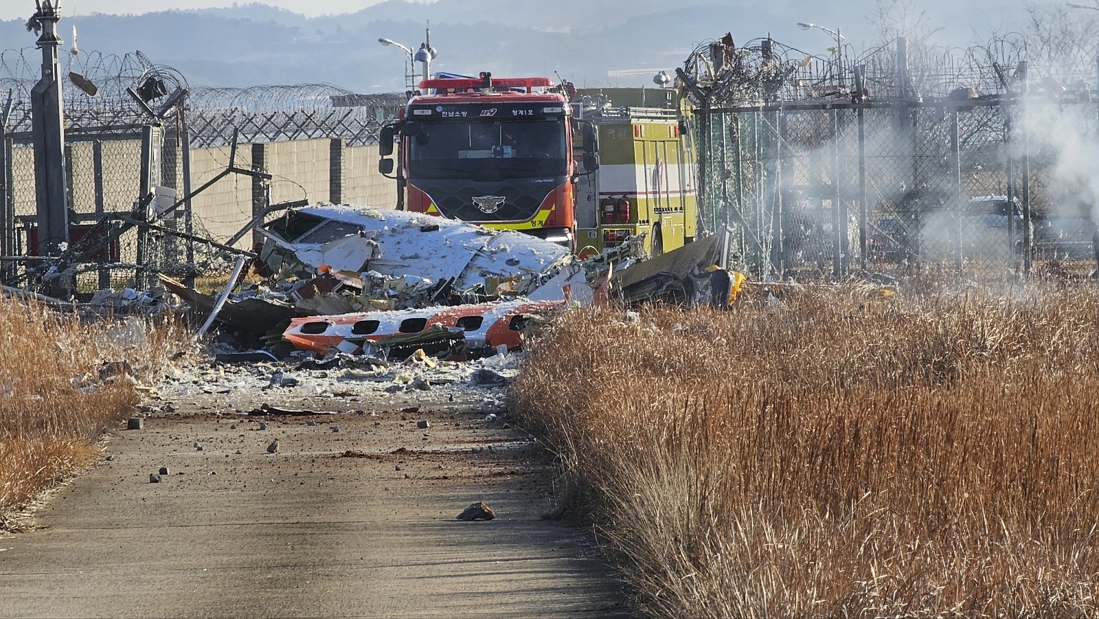 Fire engines work to extinguish a fire at the Muan International Airport in Muan, South Korea, Sunday, Dec. 29, 2024. (Maeng Dae-hwan/Newsis via AP)