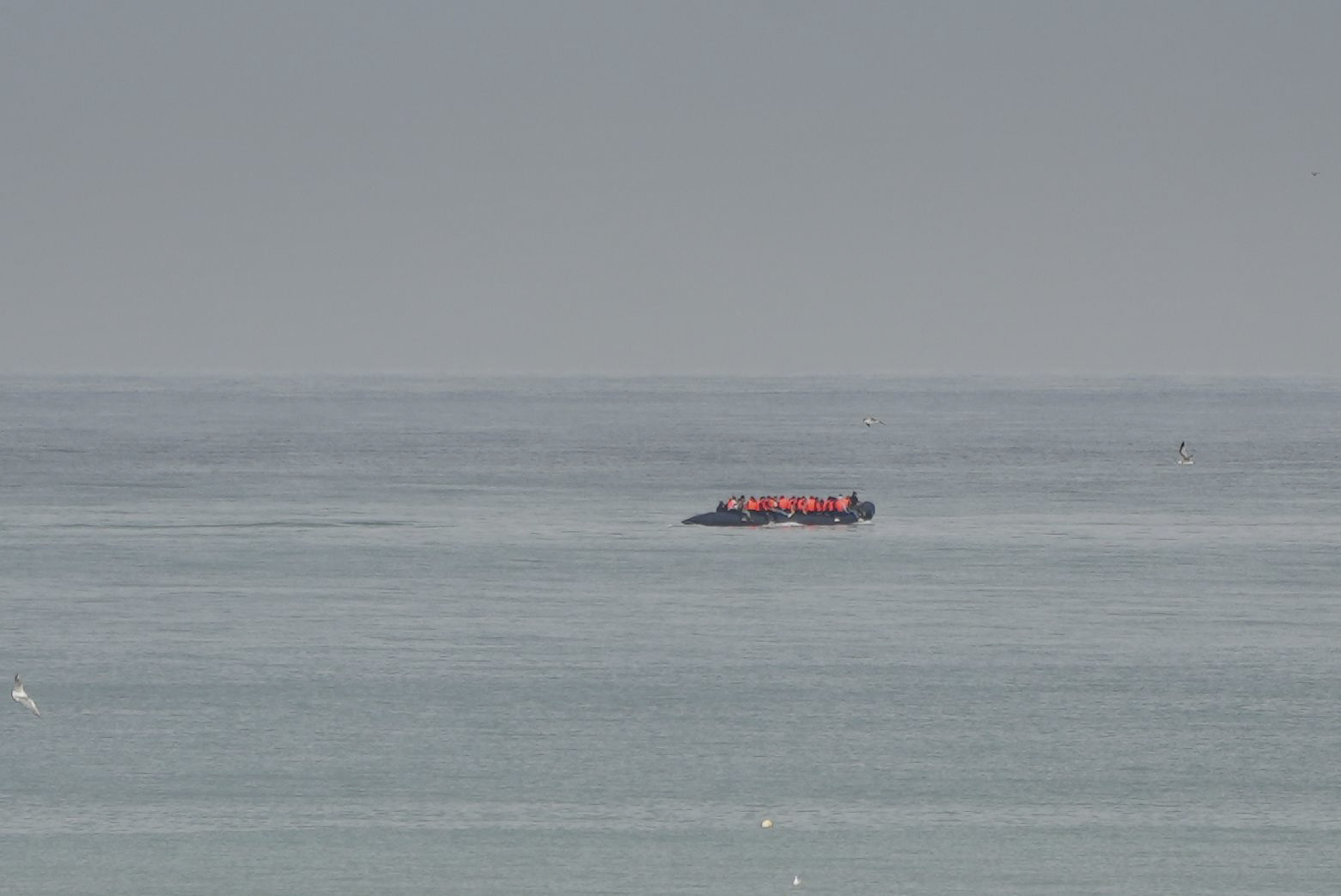 FILE- A boat thought to be with migrants is seen in the sea near the Wimereux beach, France, on Sept. 4, 2024. (AP Photo/Nicolas Garriga, File)