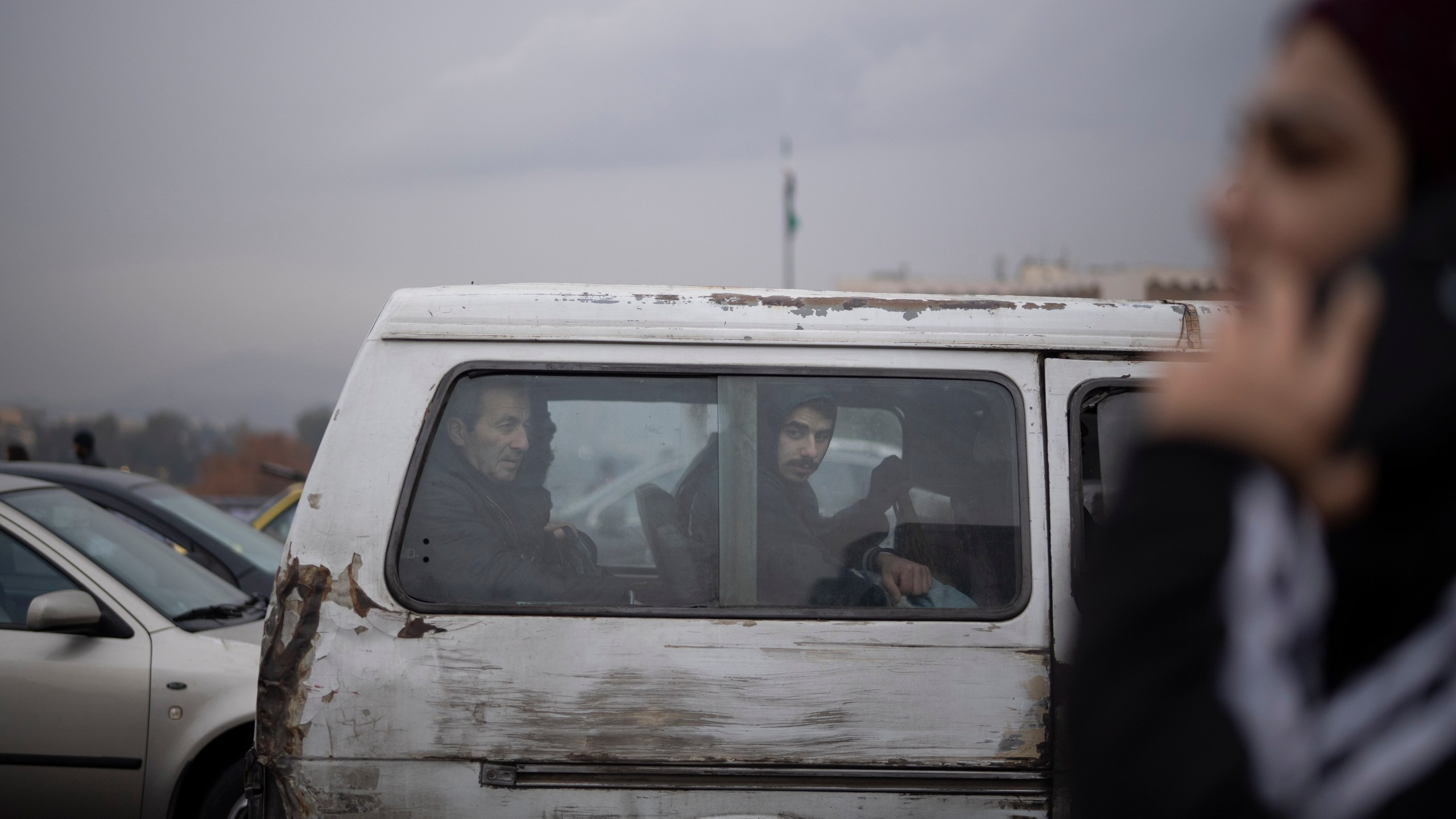 Commuters ride on a transportation van in Damascus, Syria, Sunday, Dec. 29, 2024. (AP Photo/Leo Correa)